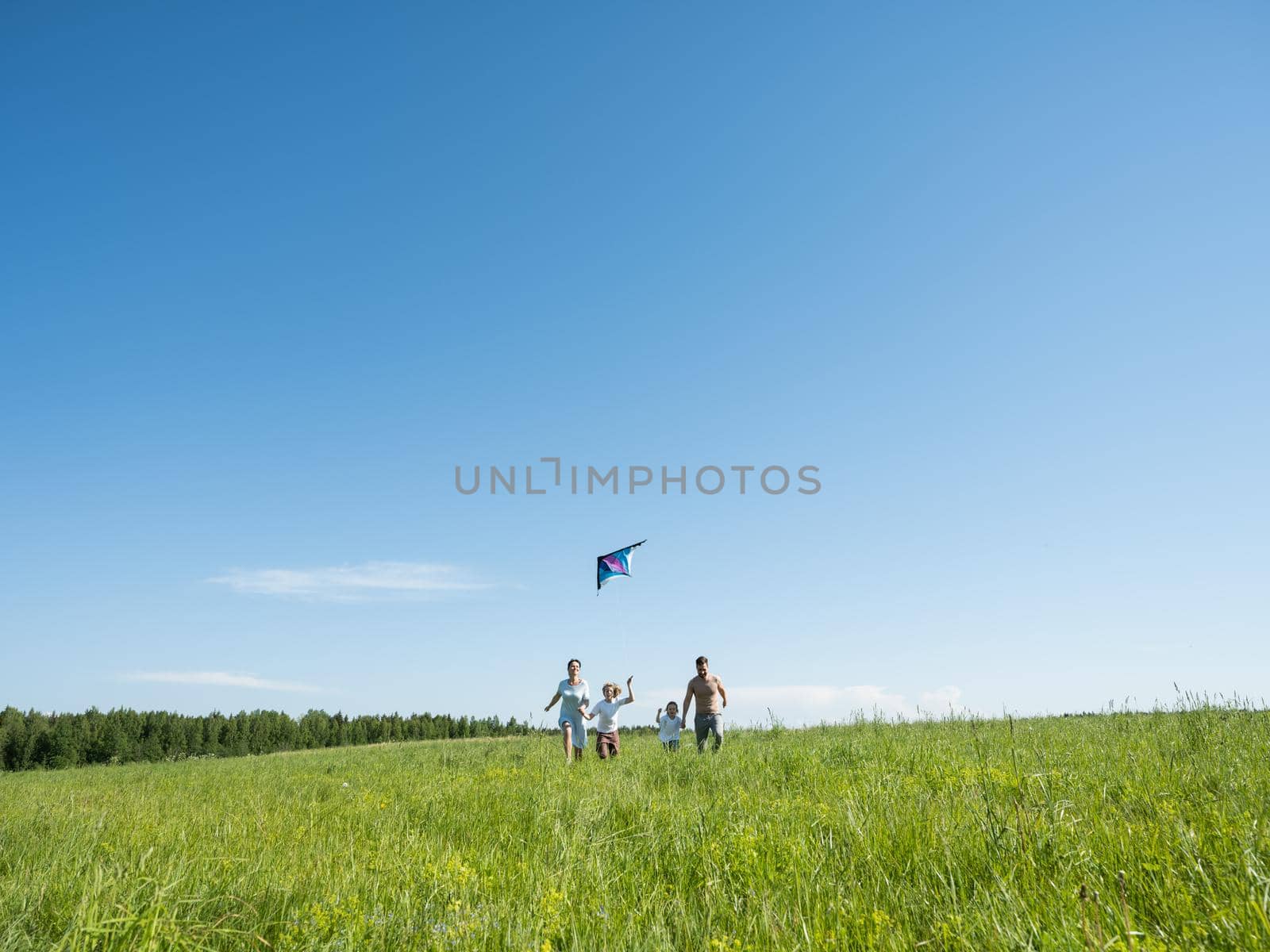 Family Flying Kite Together Outdoors by ALotOfPeople