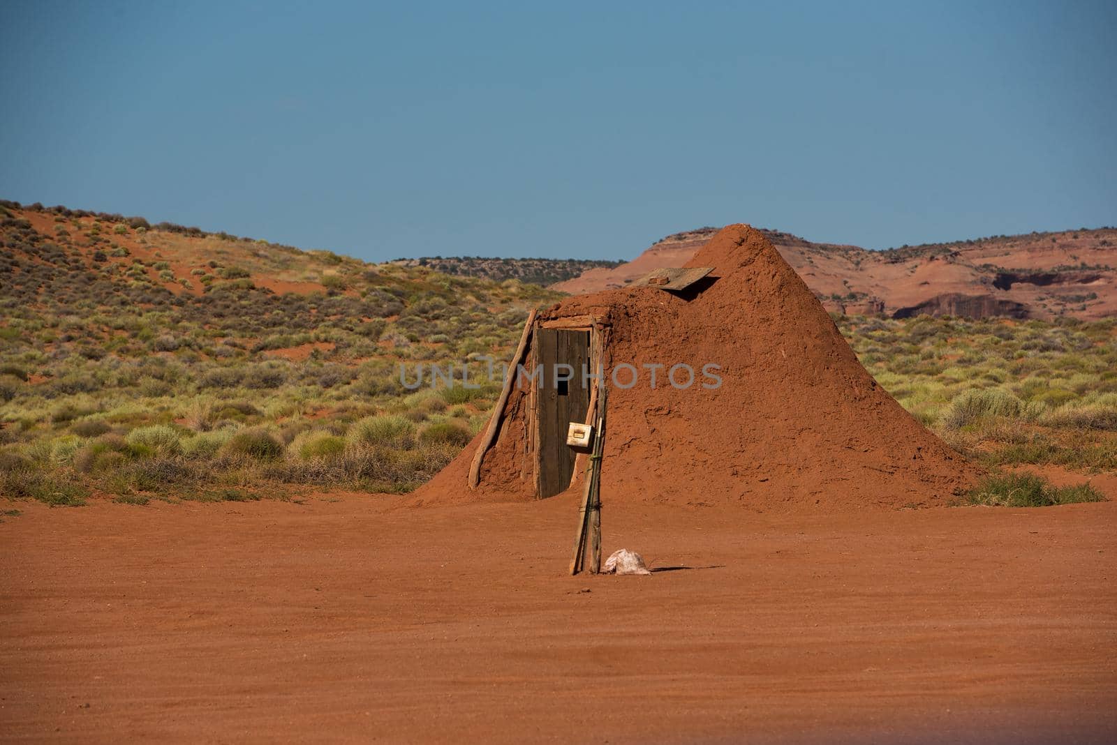 Navajo man-made clay hut with clear blue sky