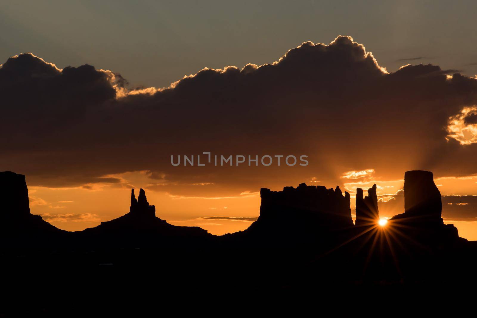 Monument Valley mesa and cloud dramatic sunset