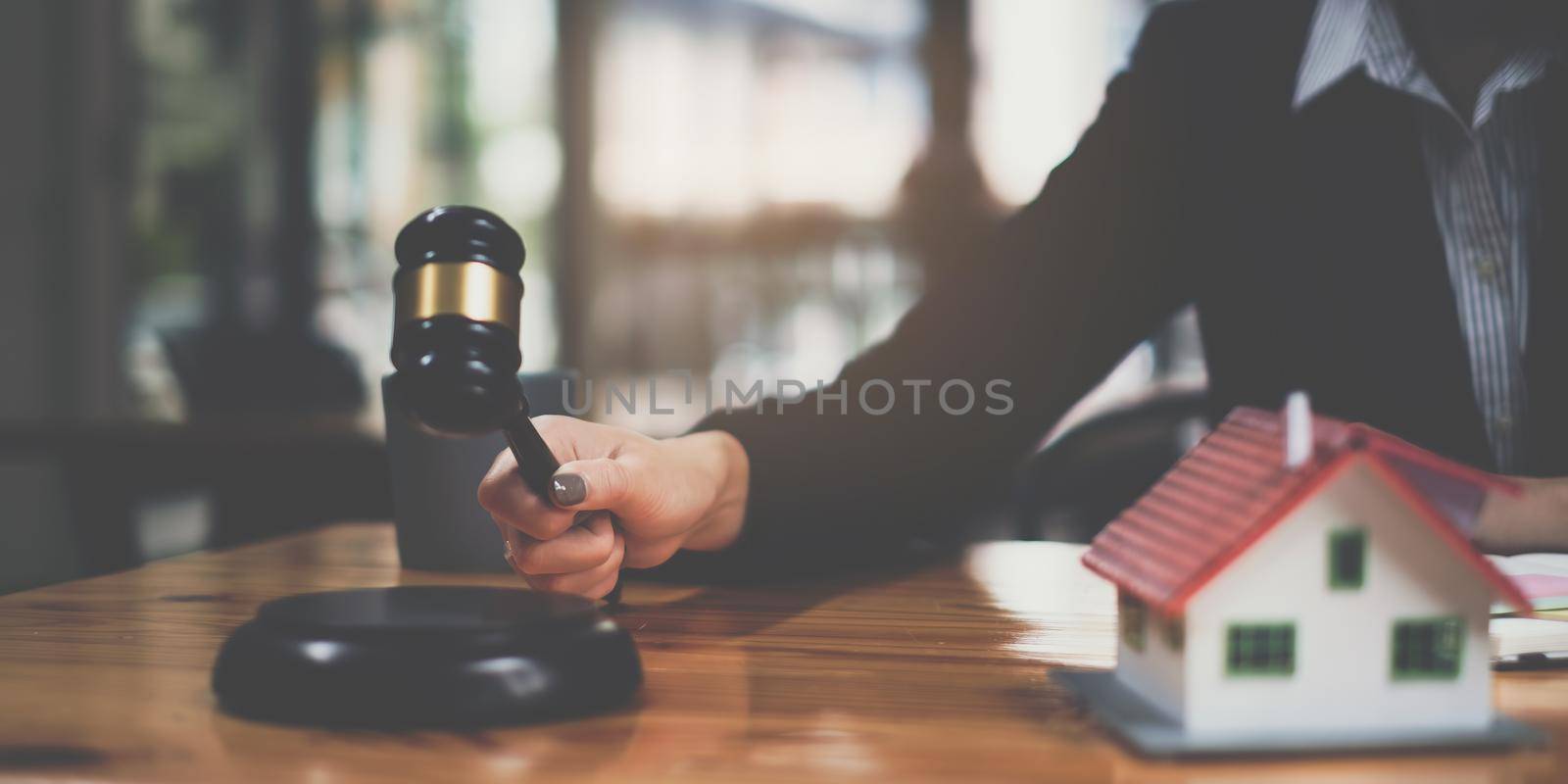 Business woman or legal advisor sitting wooden desk in office. Law, legal services, advice,Judge auction and real estate concept.