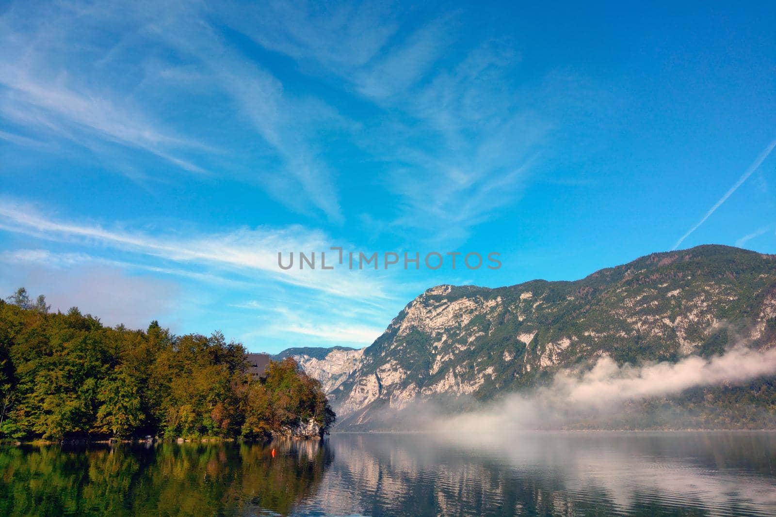 Beautiful autumn foggy morning over a mountain lake