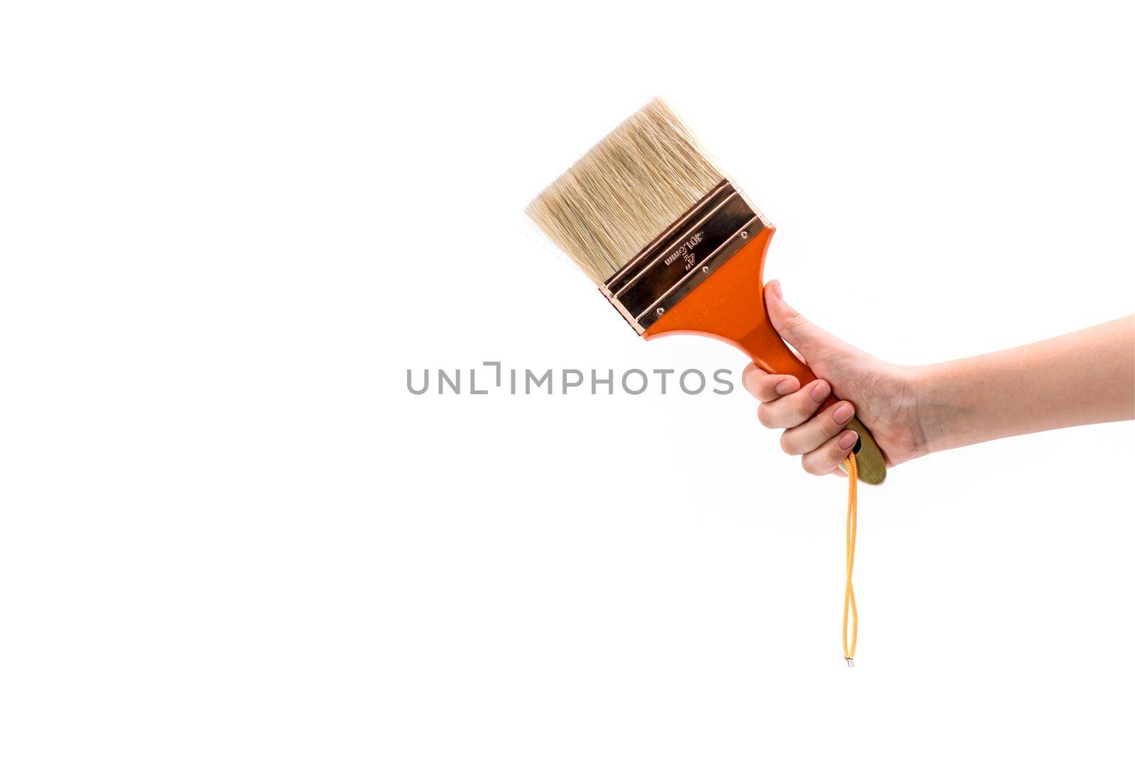 Close up human hand holding a paint brush isolated on white background.