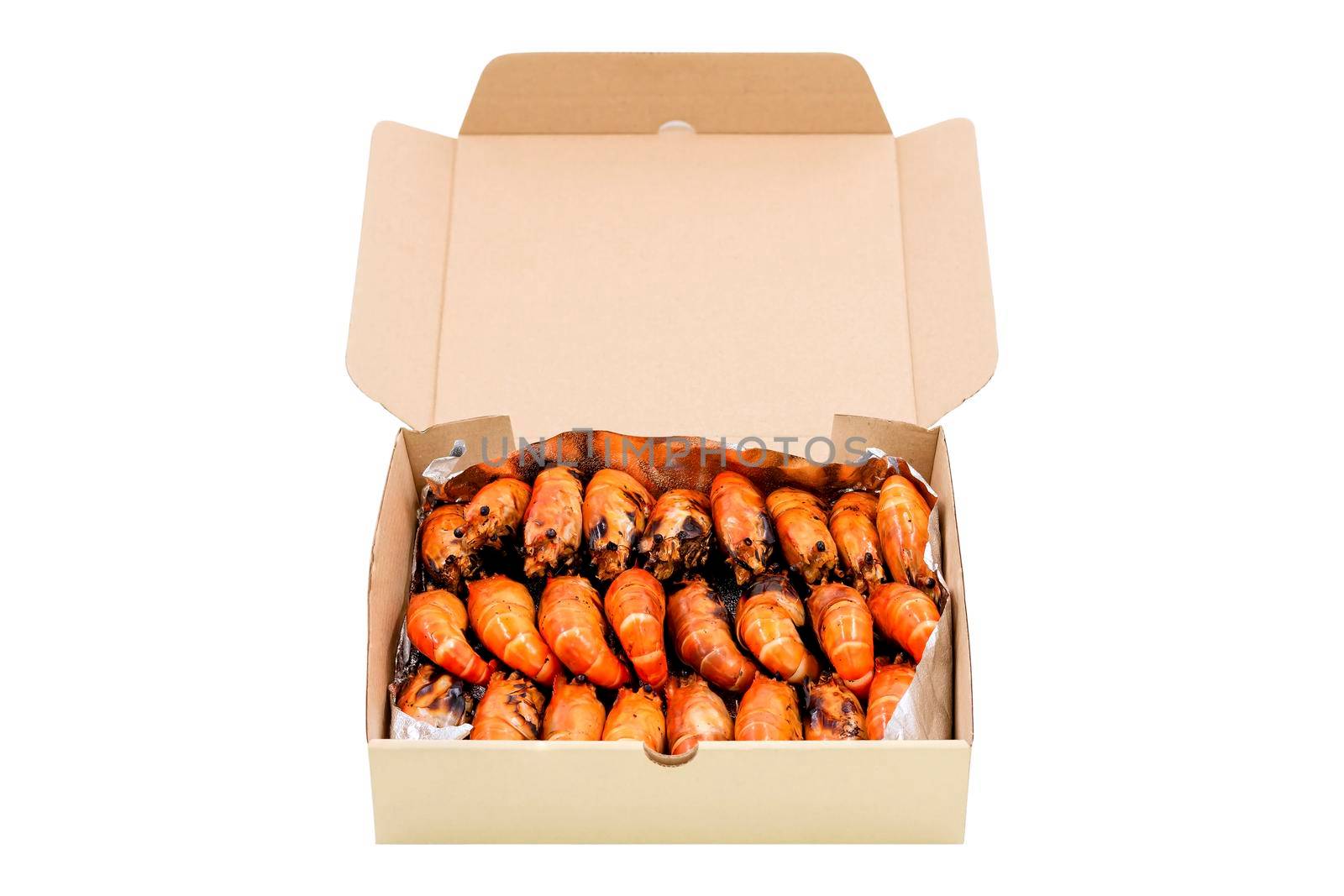 Group of grilled river prawns arrange in a paper box isolated on white background.