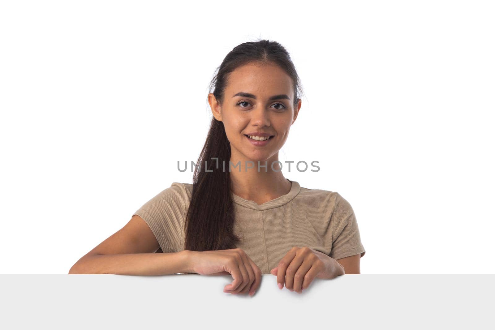 Casual latin woman with a banner isolated over a white background