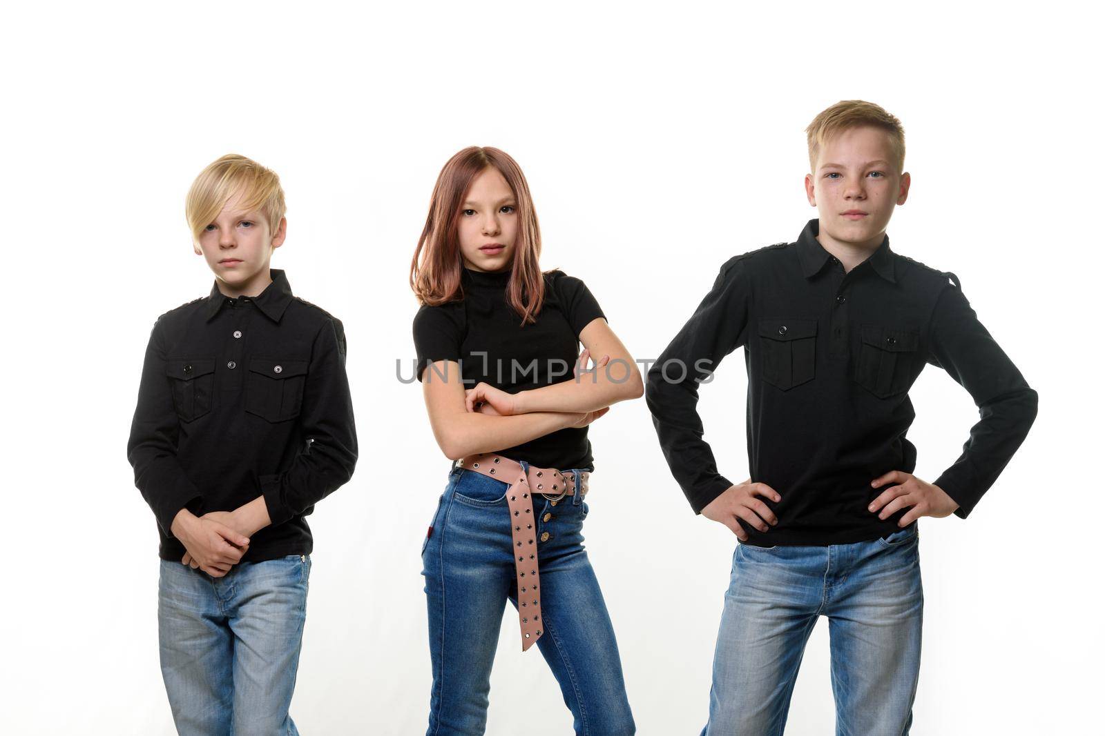 Portrait of teenagers - two boys and girls of European appearance in dark casual clothes on a white background