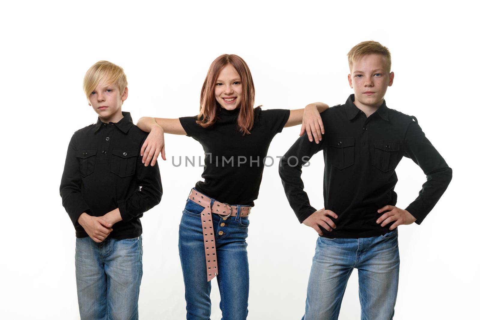 Happy little girl put her hands on brothers shoulders on white background