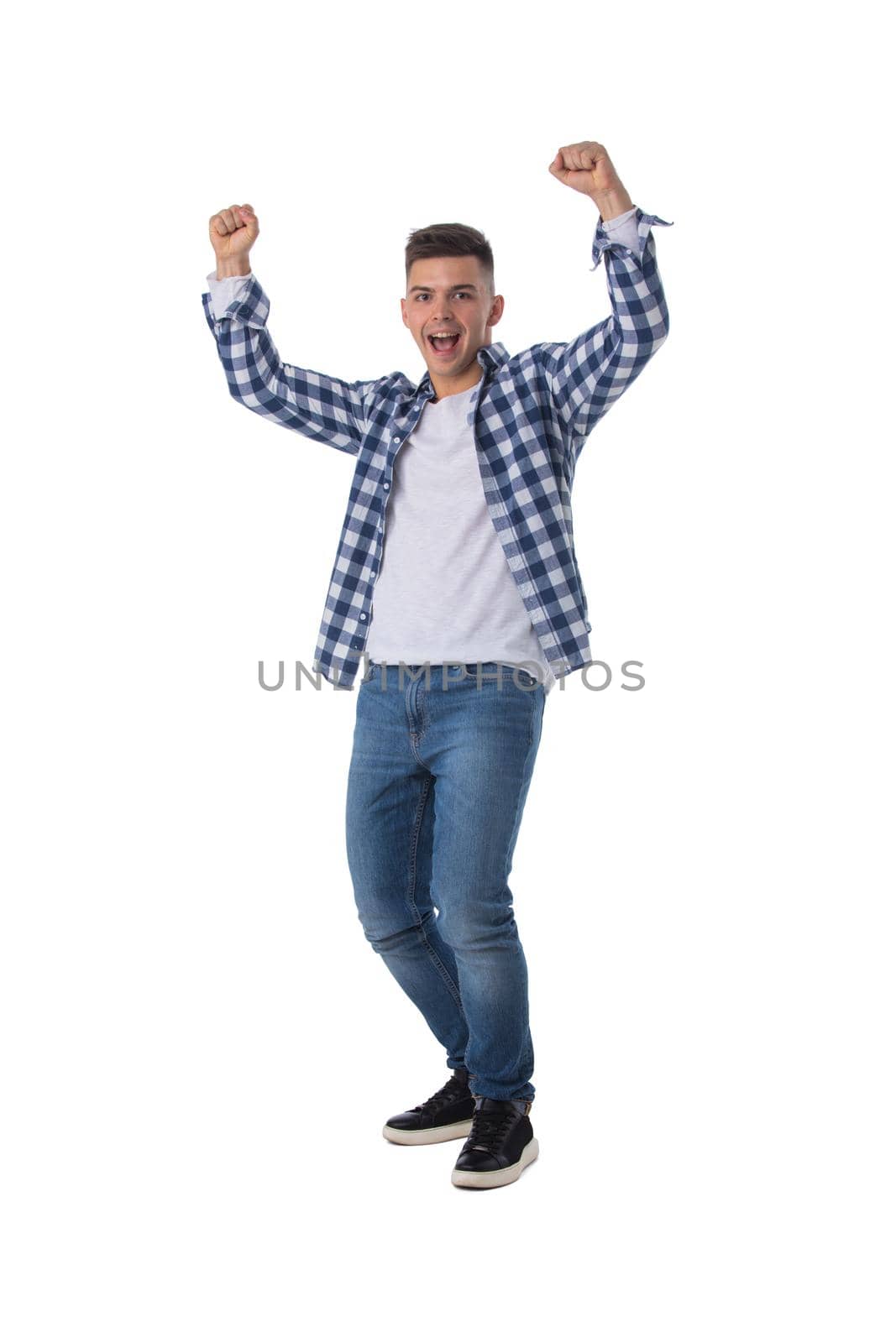 Young excited man happy smile looking at camera, hold arm hands raised up gesture, isolated over white background