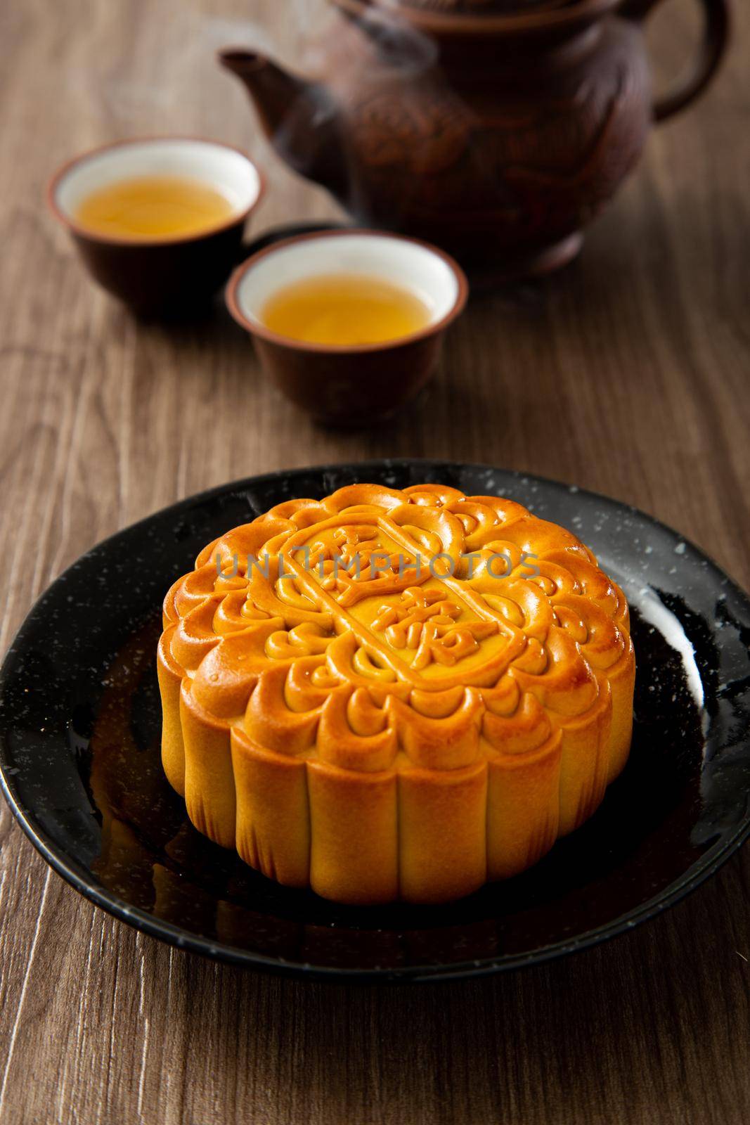 Moon cakes with Chinese tea. The Chinese character on the mooncake represent "Pandan lotus paste" in English