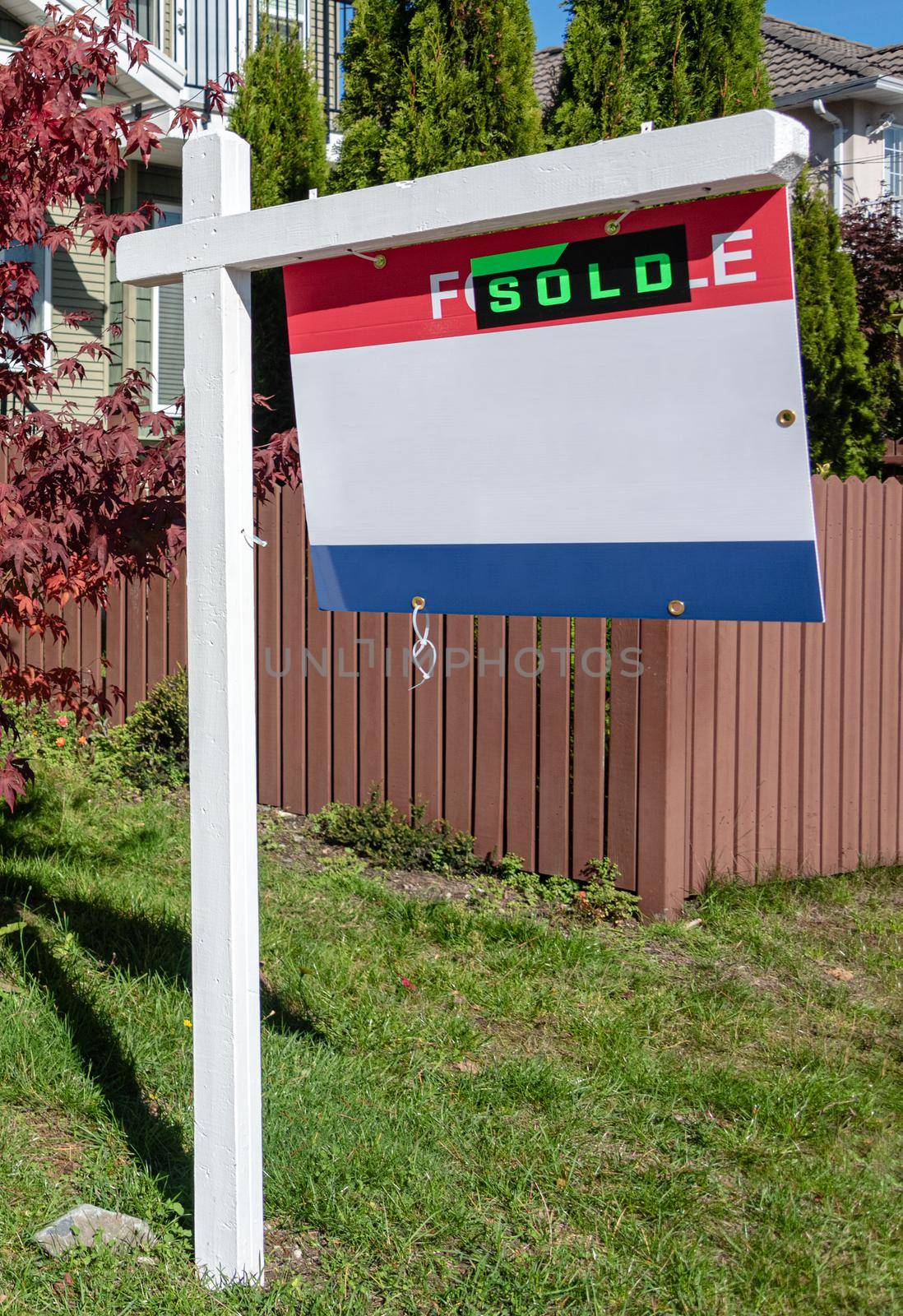 Real Estate Sold and House For Sale Sign on the Post.
