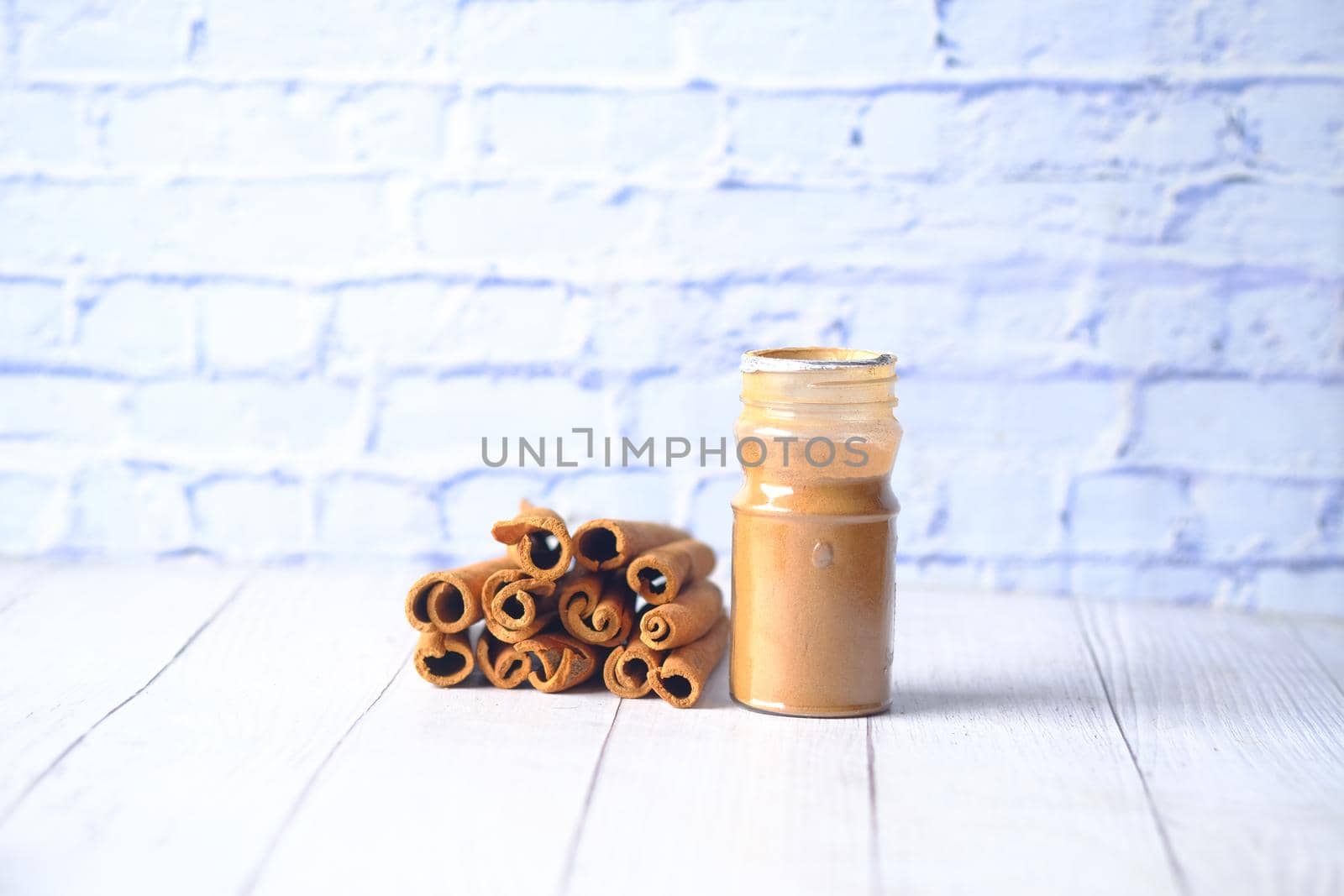 Cinnamon sticks and cinnamon powder on white background