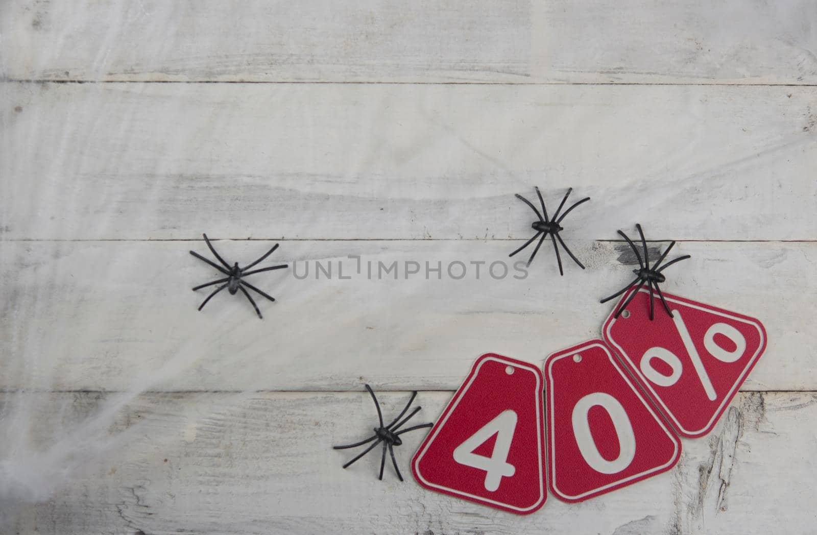 forty percent discount on the Halloween background-price tag on a rustic white wooden background by inxti