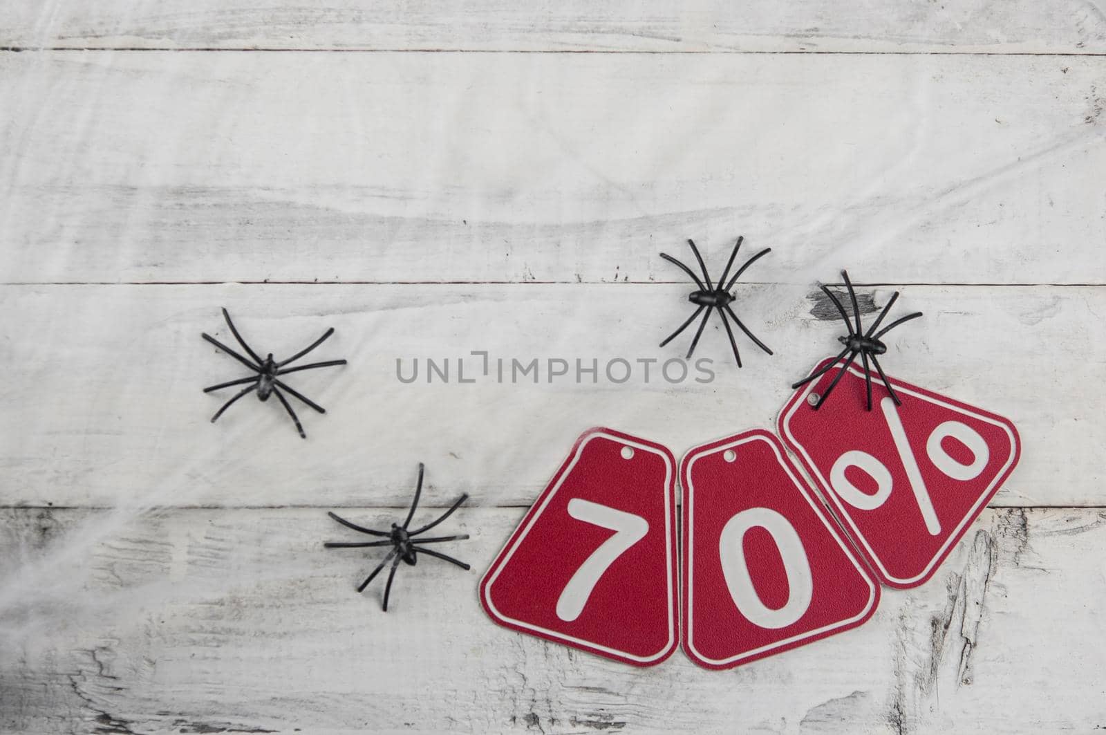 seventy percent discount on the Halloween background-price tag on a rustic old white wooden background