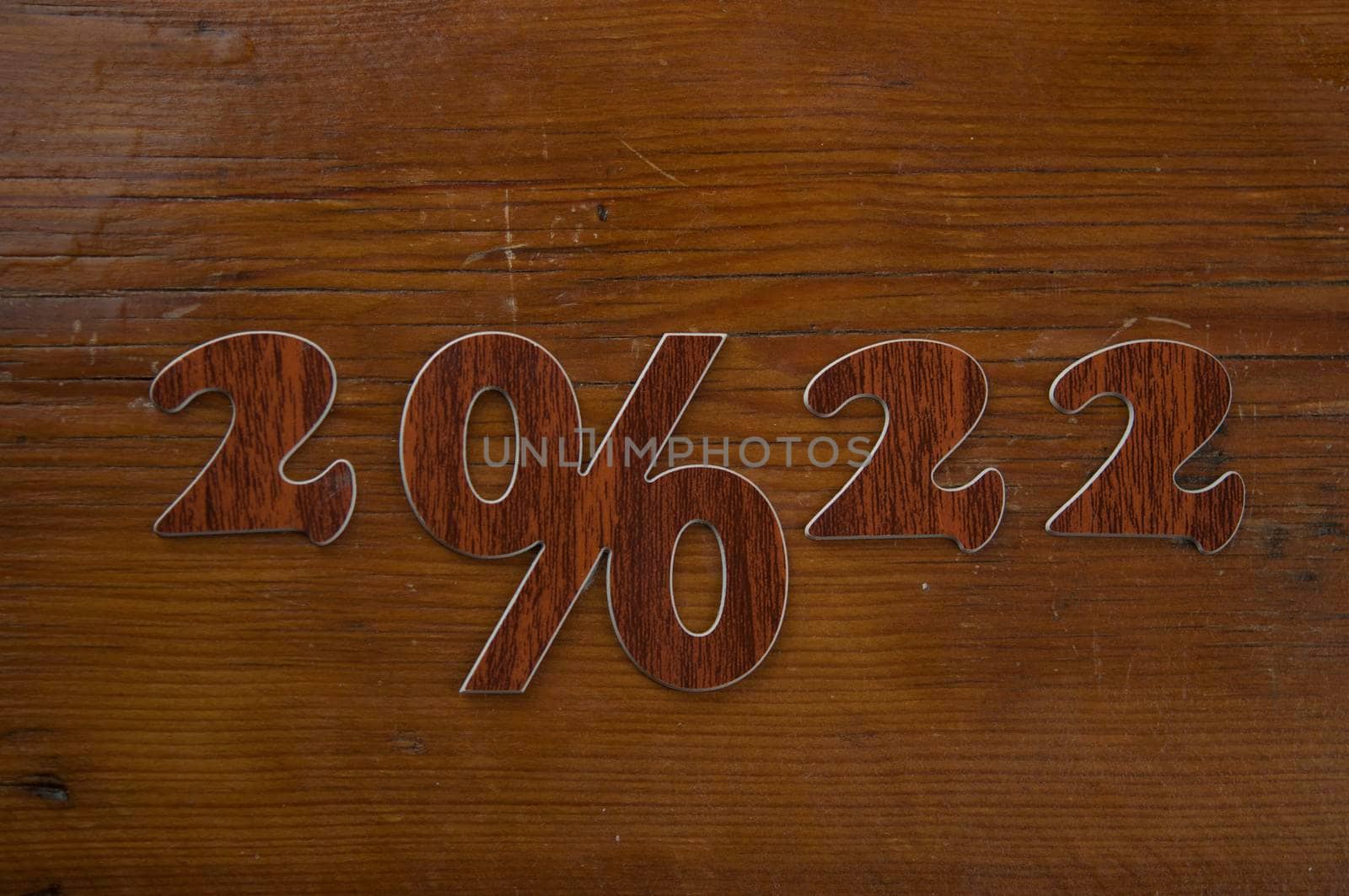 Happy New Year 2022. Number 2022 with sign percent on wooden background. Big sale, black friday  by inxti