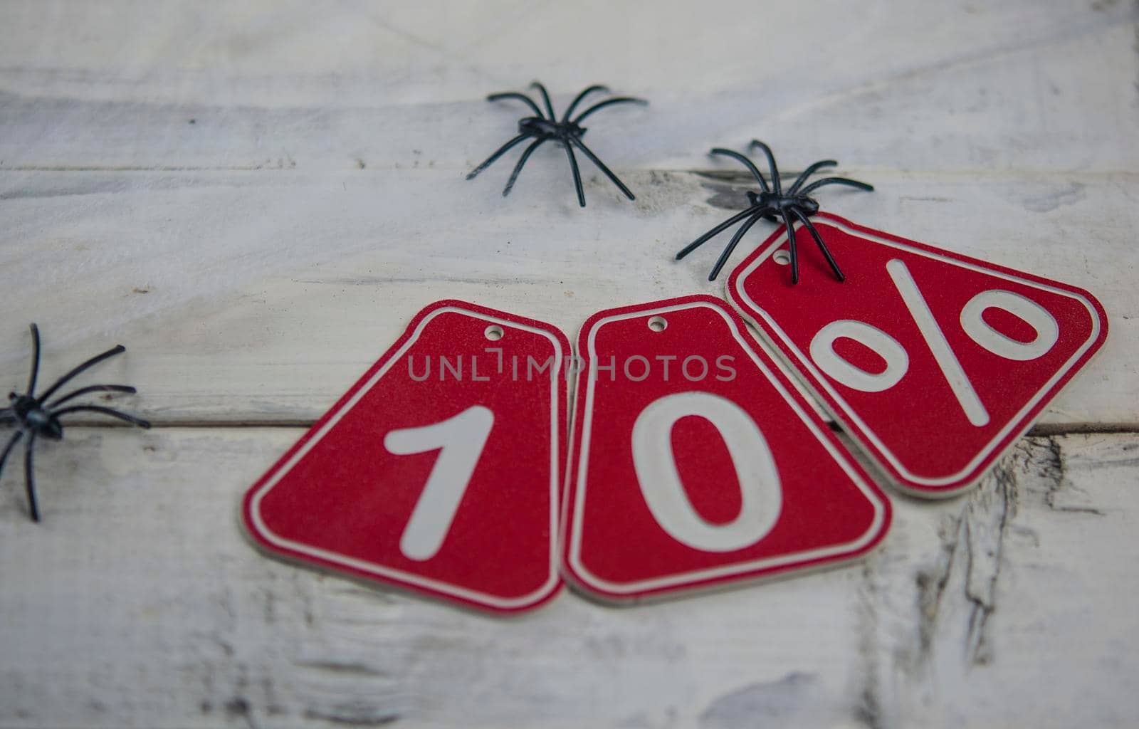 ten percent discount on Halloween background - price tag on a rustic old white wooden background