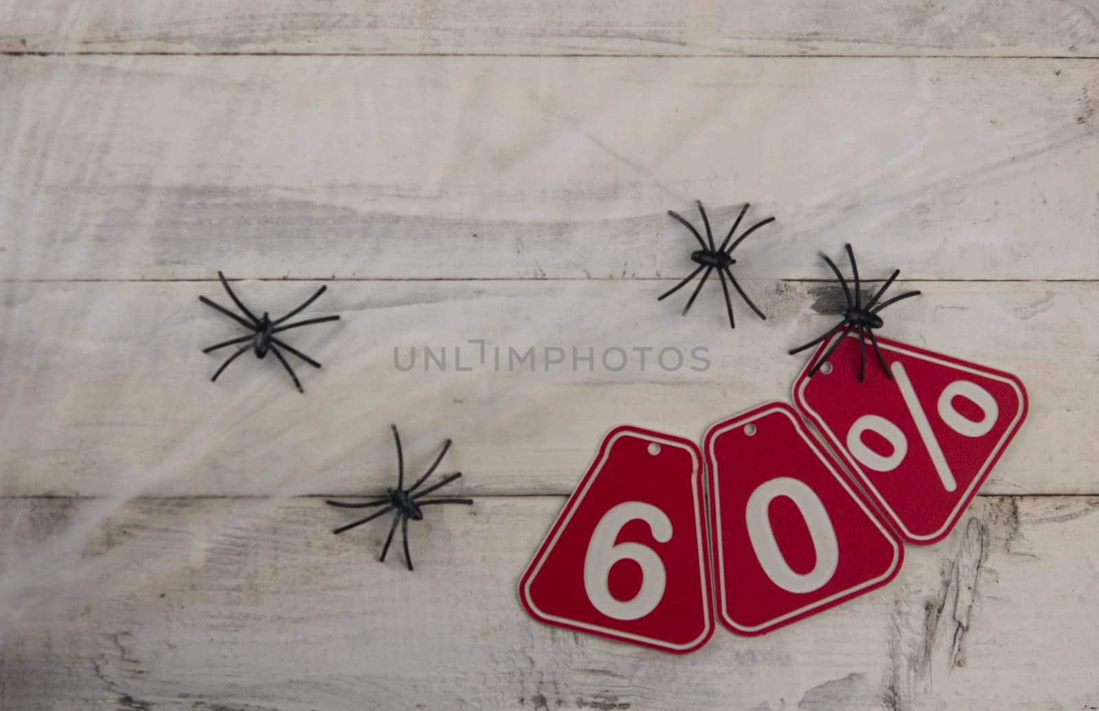 sixty percent discount on Halloween background-price tag on rustic old wooden background by inxti