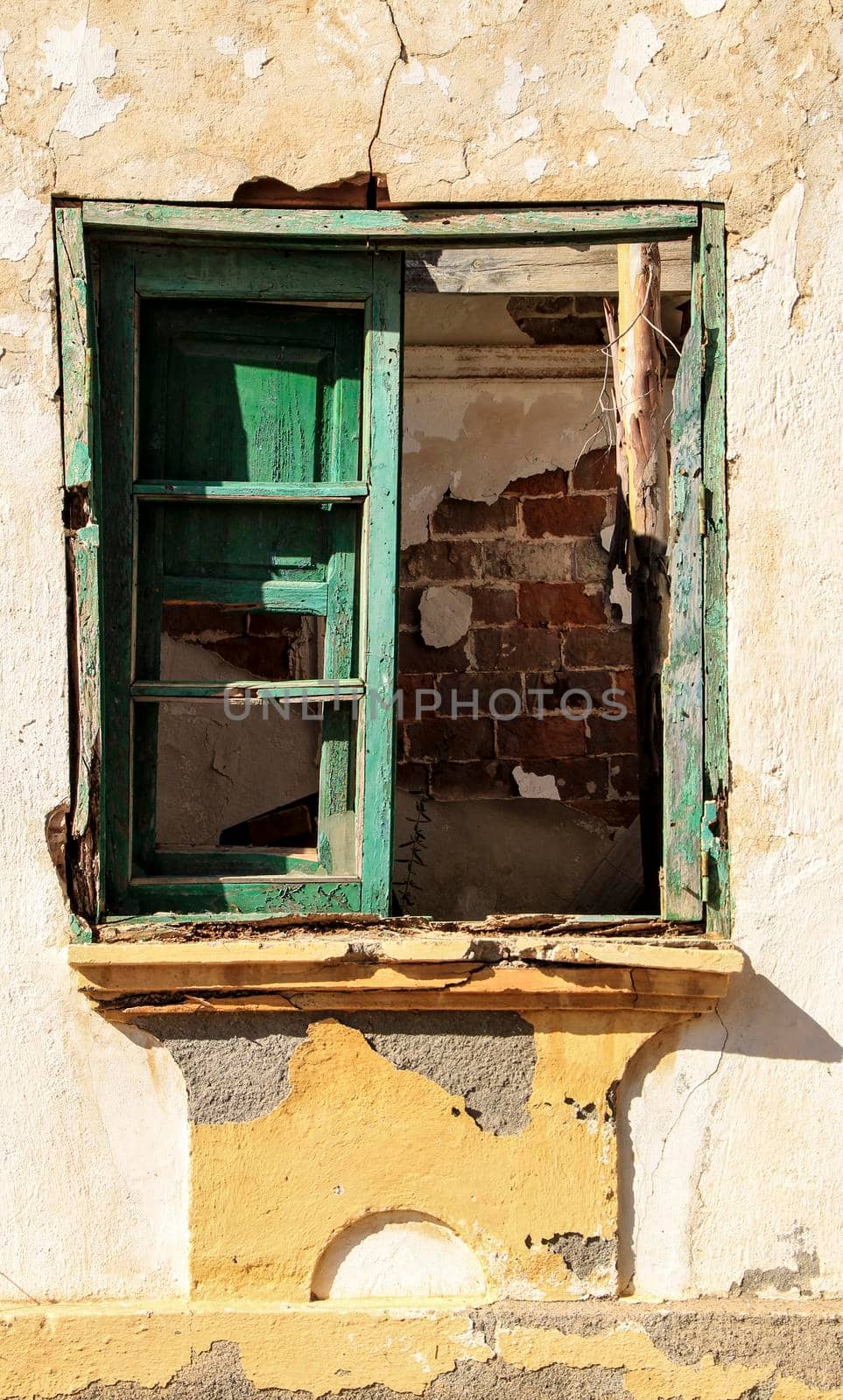 Broken and damaged window in an old house in Spain