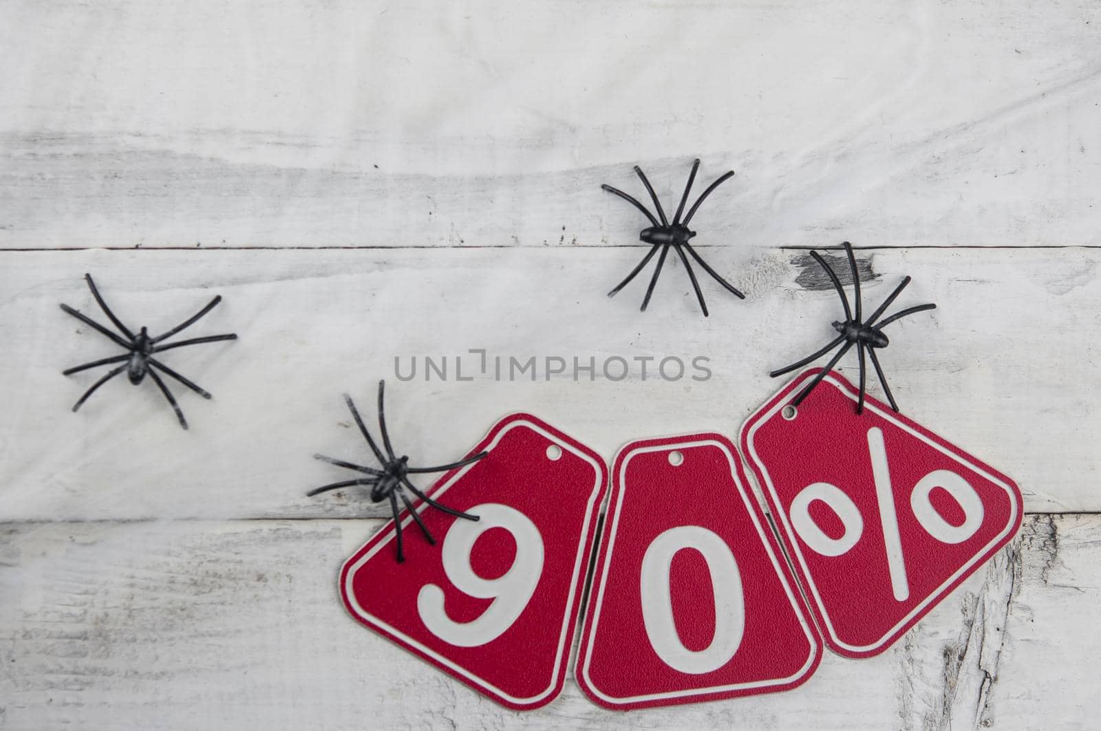 ninety percent discount on Halloween background-price tag on a old white wooden background by inxti
