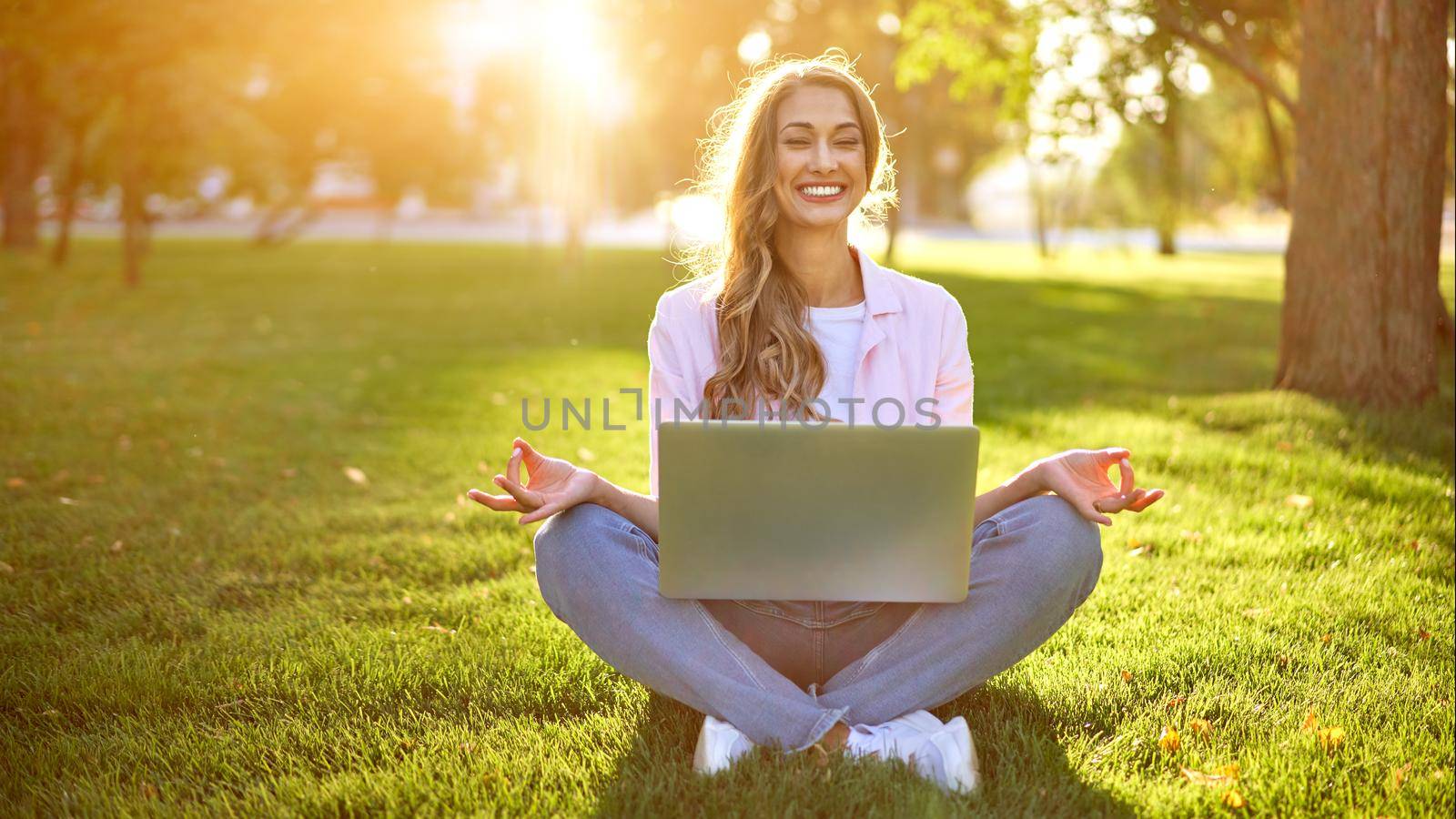 Businesswoman sitting land grass summer park using laptop Business person working remote. Outdoor Successful european caucasian woman freelancer make video call teacher study work online lessons