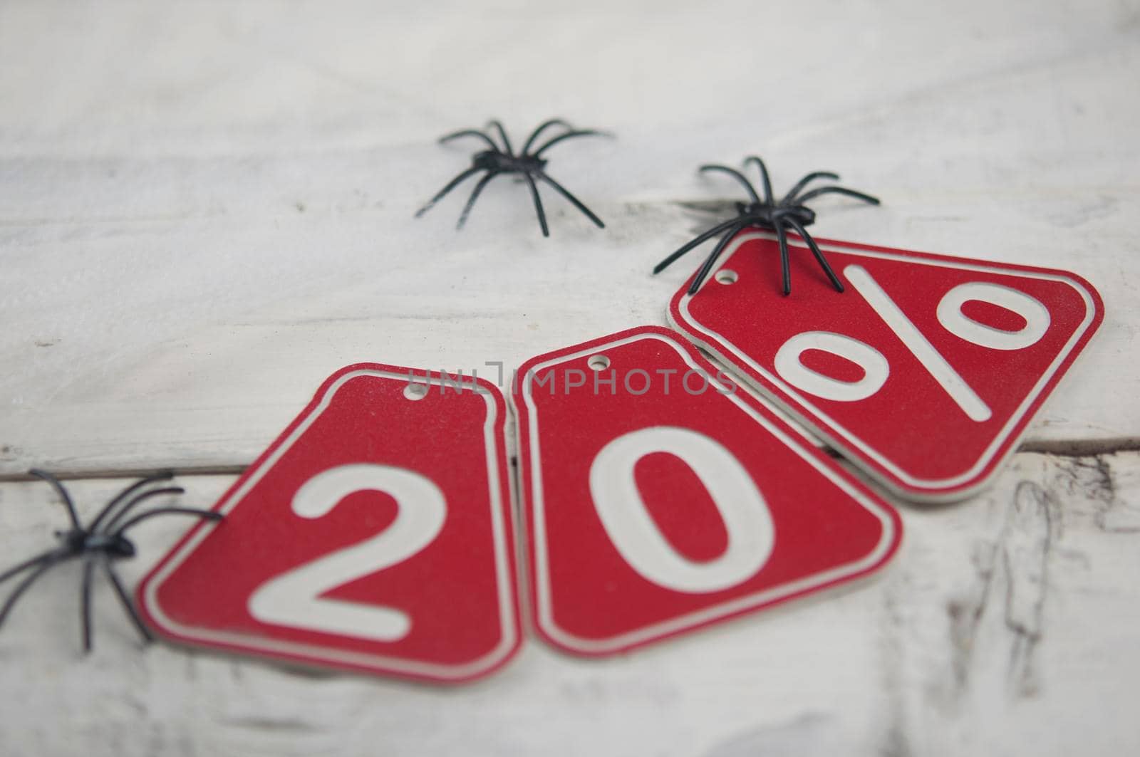 twenty percent discount on Halloween background-price tag on a rustic old white wooden background