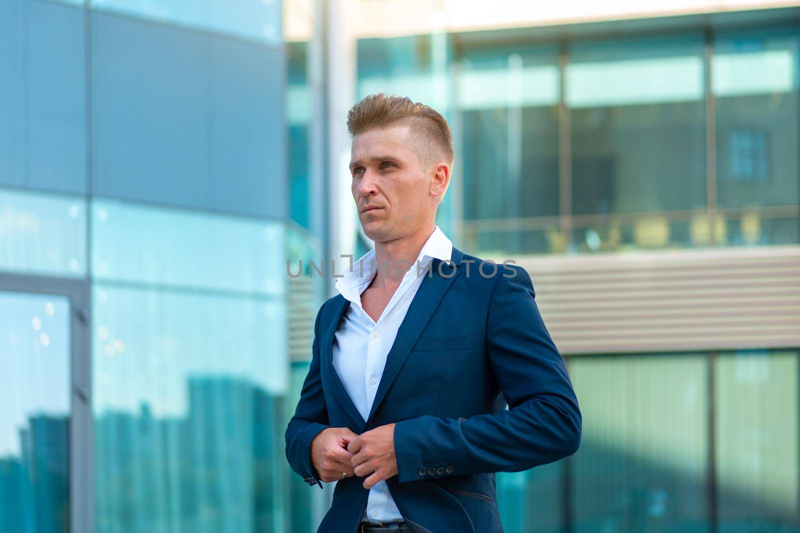 Business. Businessman Standing City Street Office Building Handsome Caucasian Male Business Person Portrait Corporative Building Background Successful Young Adult Manager buttoning his jacket