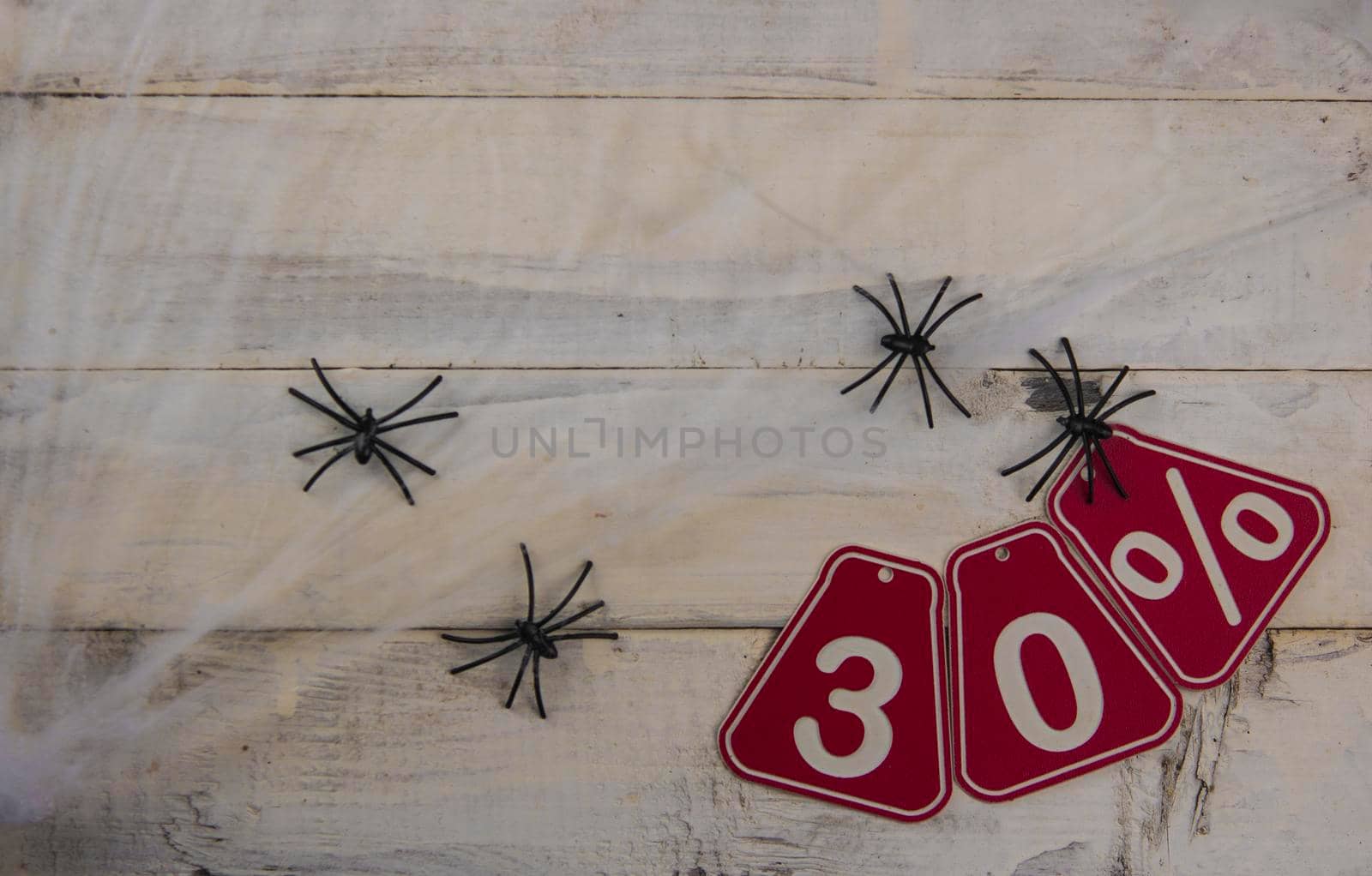 thirty percent discount on Halloween background - price tag on a rustic old wooden background by inxti
