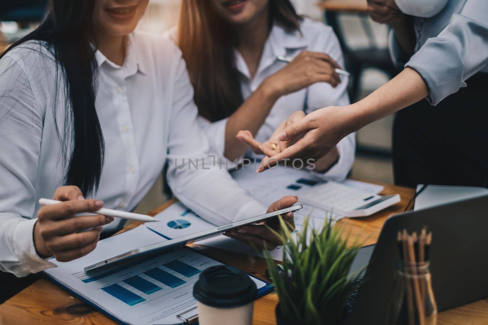 Group of Businesswoman and Accountant checking data document on paperwork for investigation of corruption account. Anti Bribery concept. by itchaznong