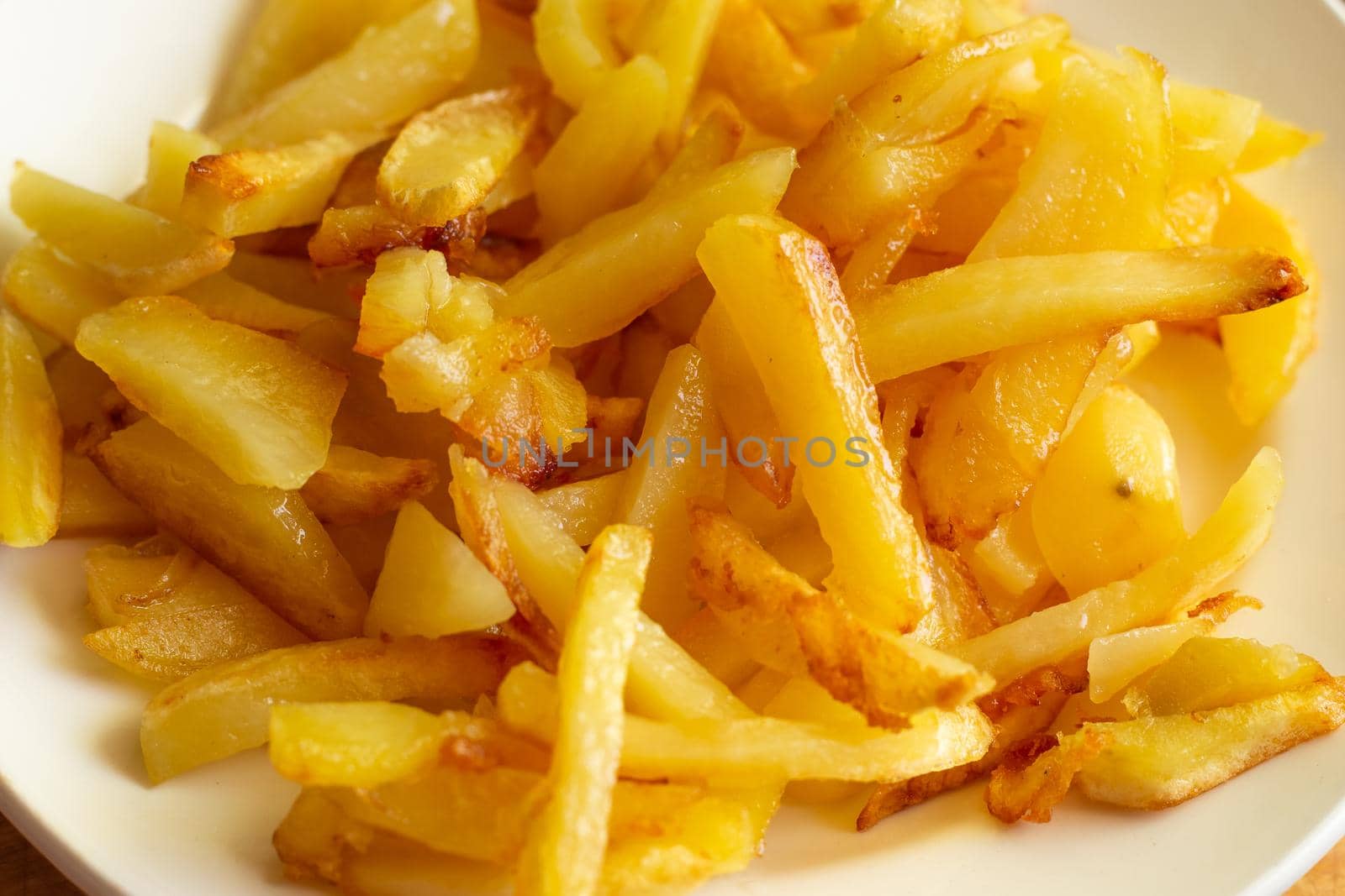 a plate of mouth-watering fresh fried potatoes with a golden crust.