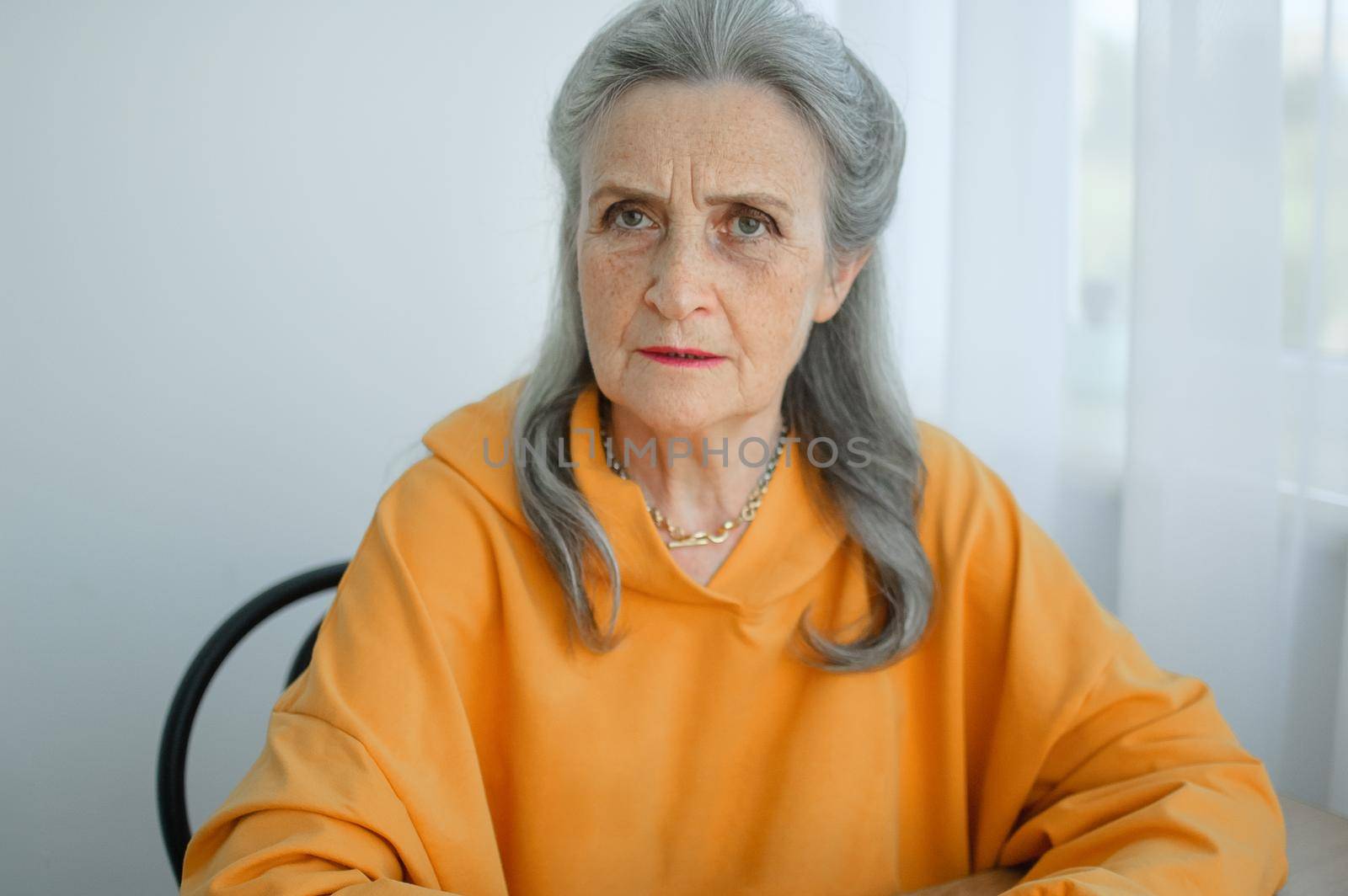 Closeup portrait of angry upset senior mature woman talking with someone and looking at the camera. Negative emotion, facial expression, scandal.