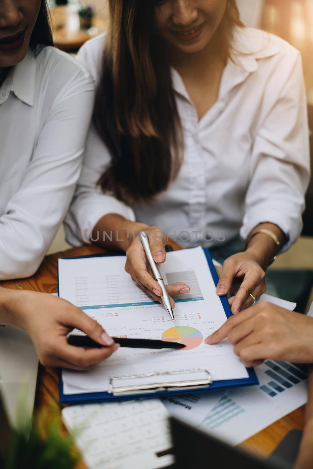 Group of Businesswoman and Accountant checking data document on paperwork for investigation of corruption account . Anti Bribery concept. by itchaznong