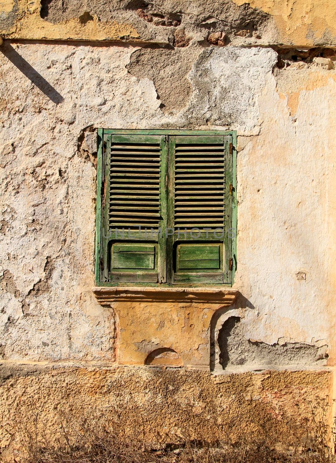 Broken and damaged window in an old house in Spain