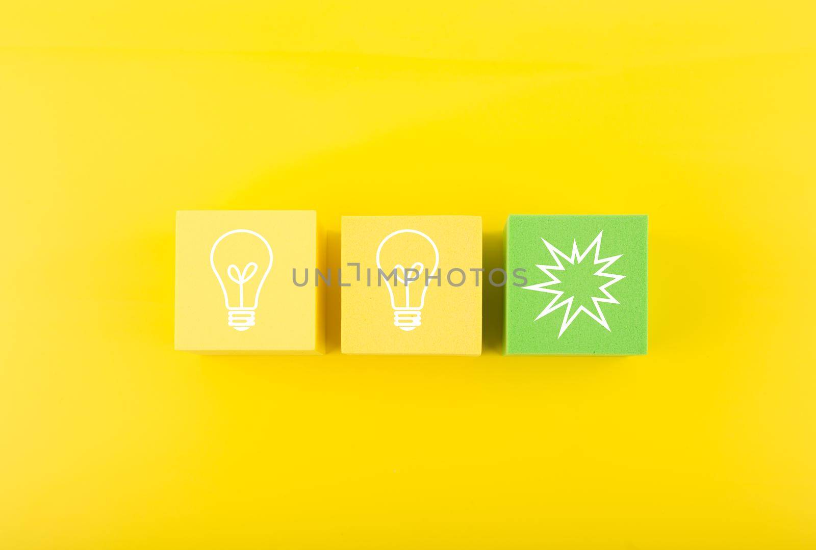 Creativity concept. Light bulbs on yellow and green toy blocks against bright yellow background by Senorina_Irina