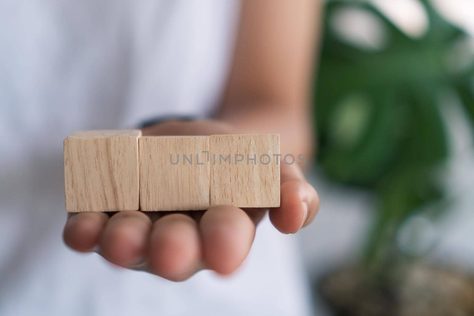 Blank wooden cube that you can put text or icon on in hand hold background