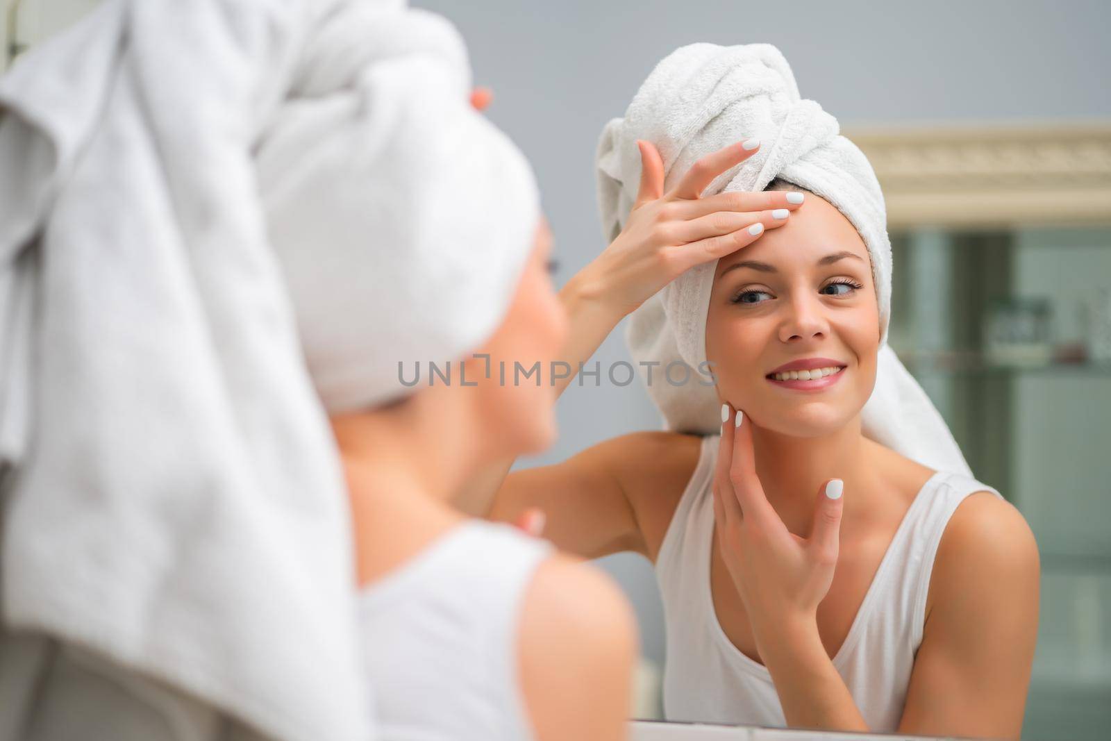 Portrait of young happy woman who is satisfied with her skin.