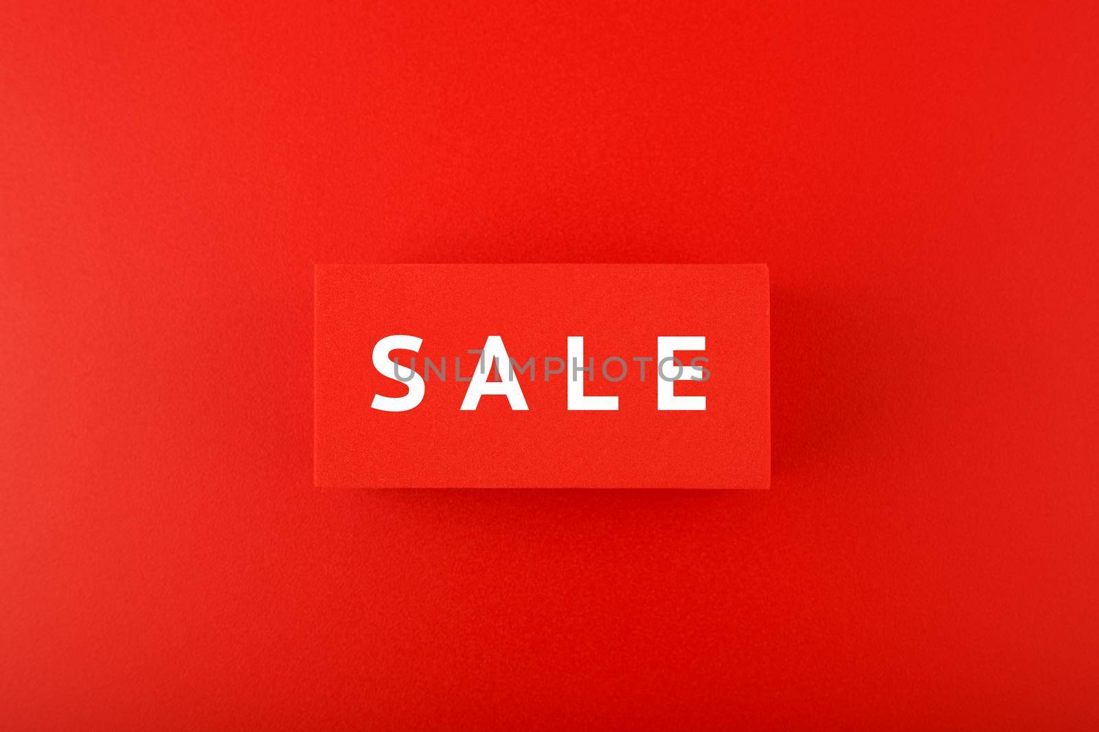 Sale elegant minimal concept in red colors. Sale written on red tablets on red background. 