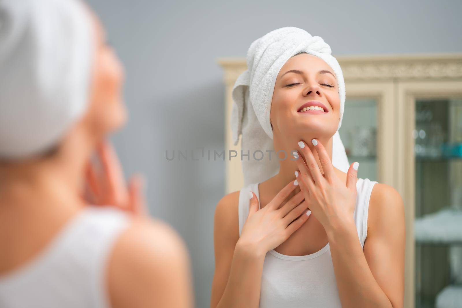 Portrait of young happy woman who is satisfied with her skin.