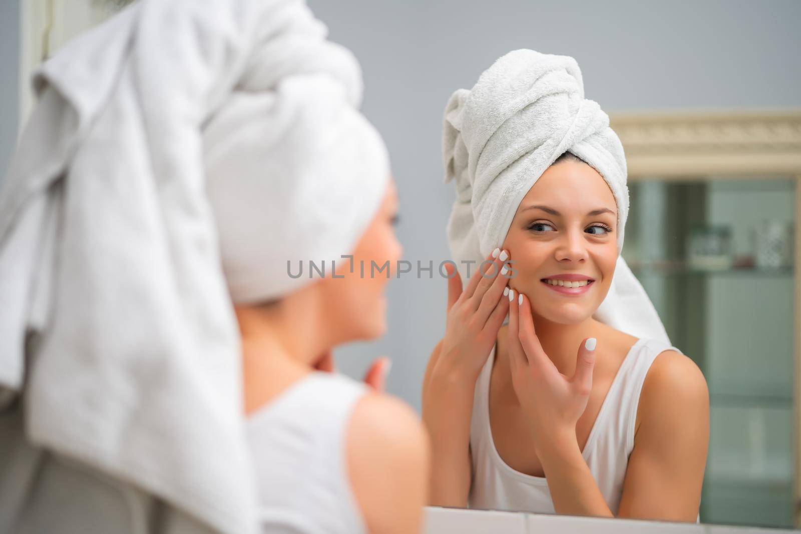 Portrait of young happy woman who is satisfied with her skin.