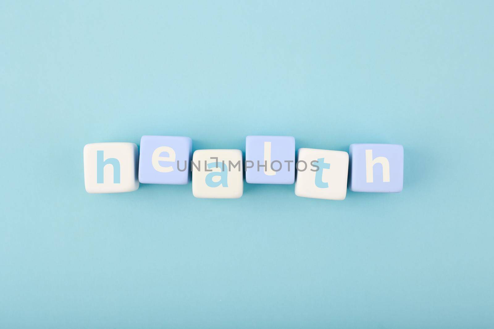 Health single word written on white and blue cubes in a row on bright blue background. Concept of mental and physical health, medications, life insurance or wellbeing