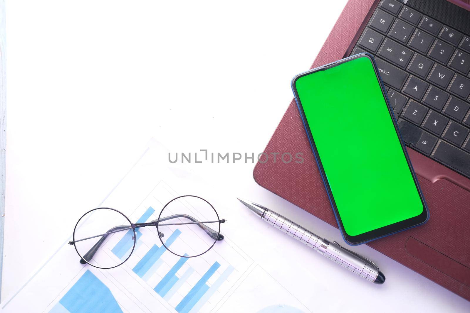 smart phone with empty screen, laptop on wooden background .