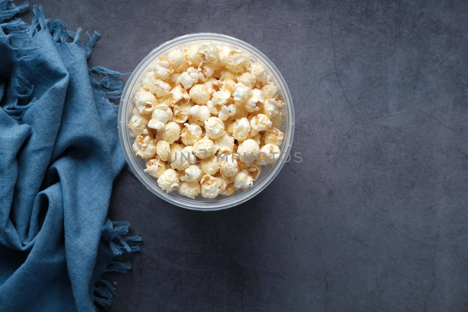 popcorn in a bowl on wooden des.