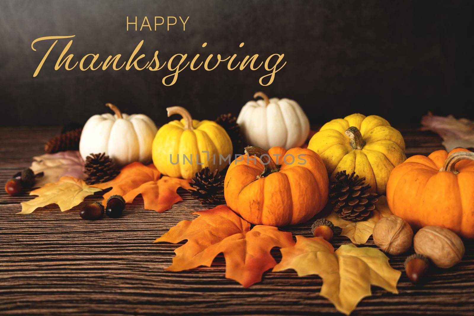 Happy Thanksgiving Day with pumpkin and nut on wooden table