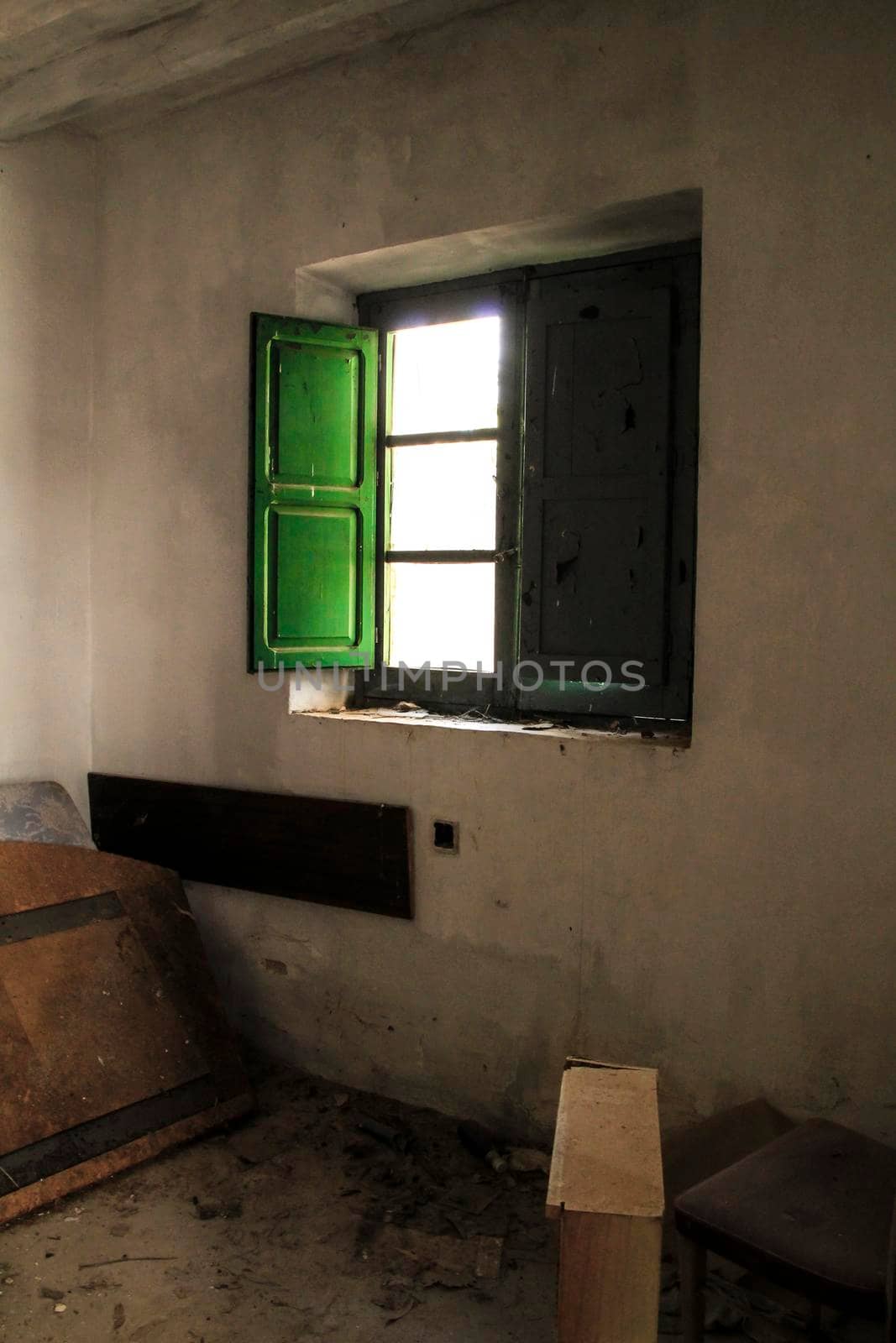 Green wooden window of old abandoned house in Spain.