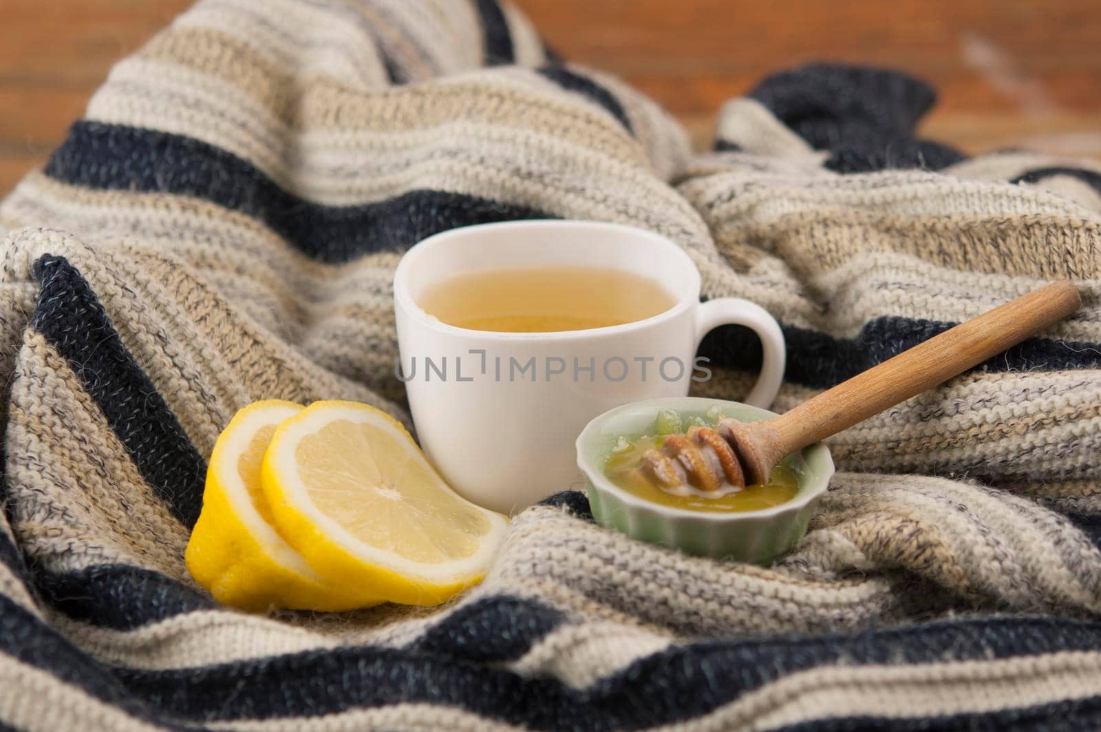 cozy autumn Breakfast with tea in white cup with honey and a warm knitted sweater   by inxti