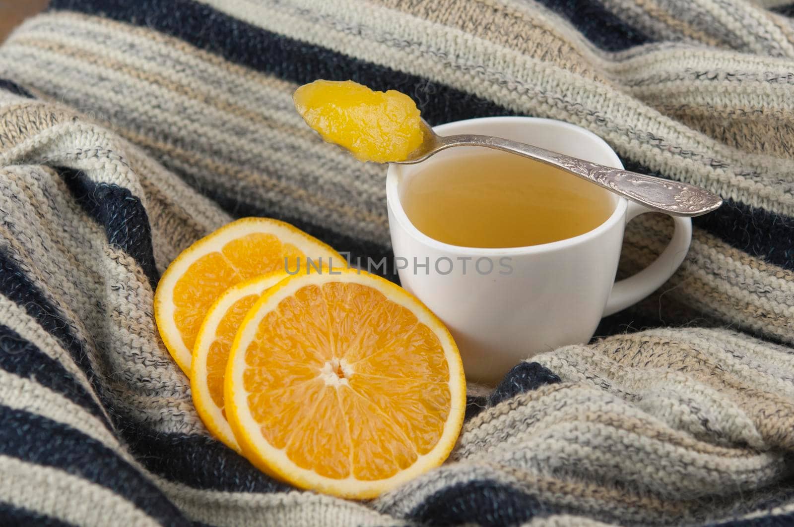 cozy autumn Breakfast with tea in white cup with honey and a warm knitted sweater   by inxti
