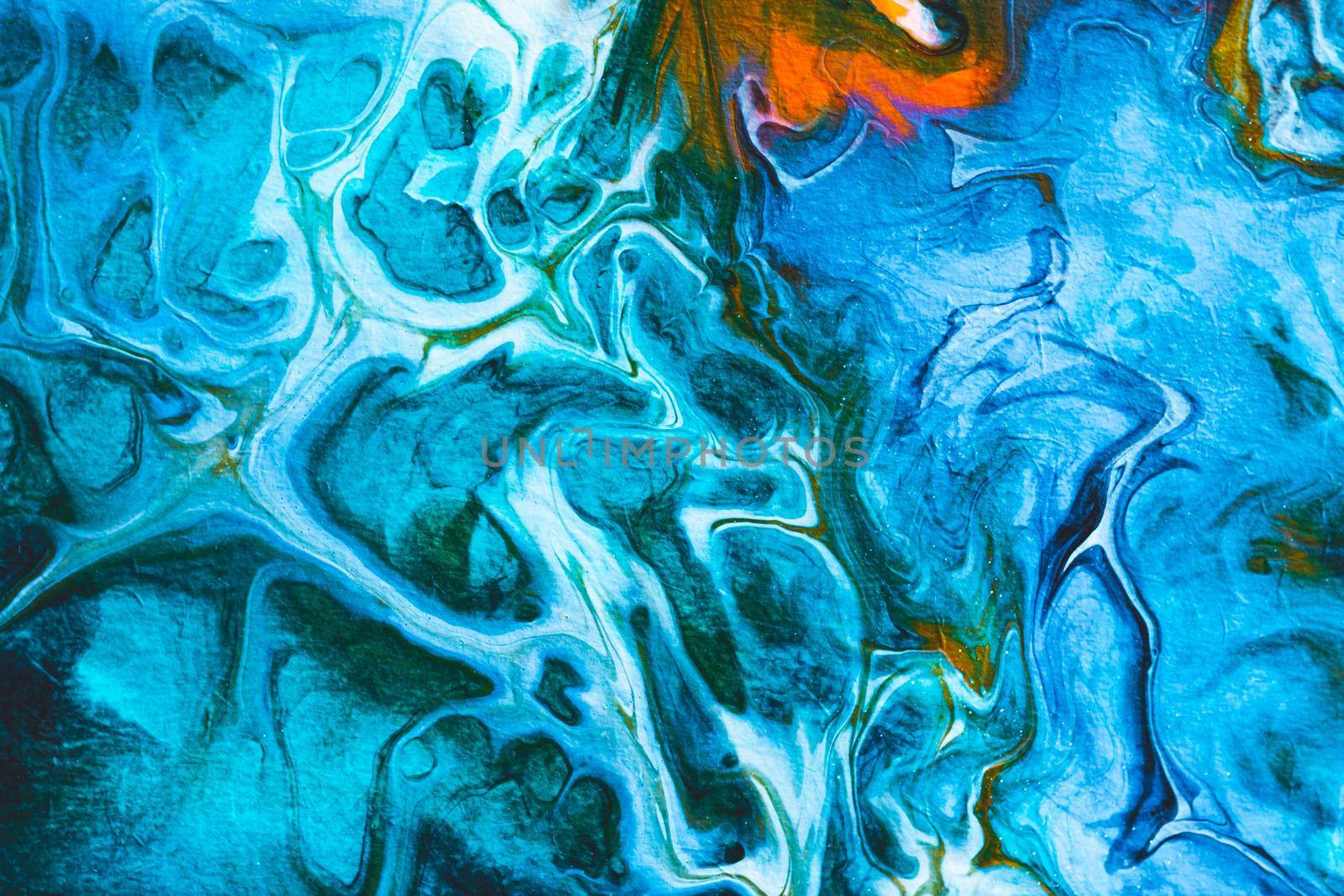 Abstract background from spilled paints. Multi-colored paints on canvas. Liquid is poured over the table.