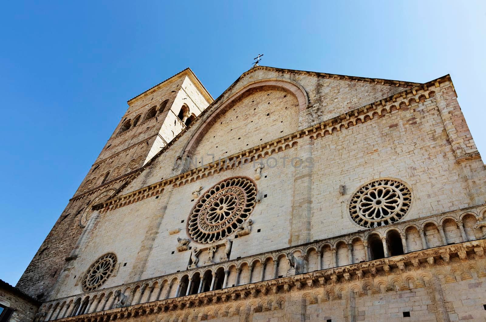 Facade of Assisi Cathedral or Cattedrale di San Rufino in Romanesque style with beautiful ornate  rose window