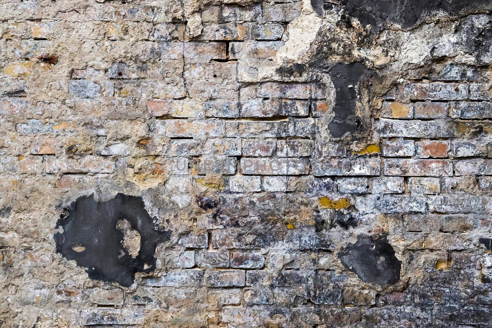 Wall in a steel mill with clear signs of use, cracks and pipes. High resolution background