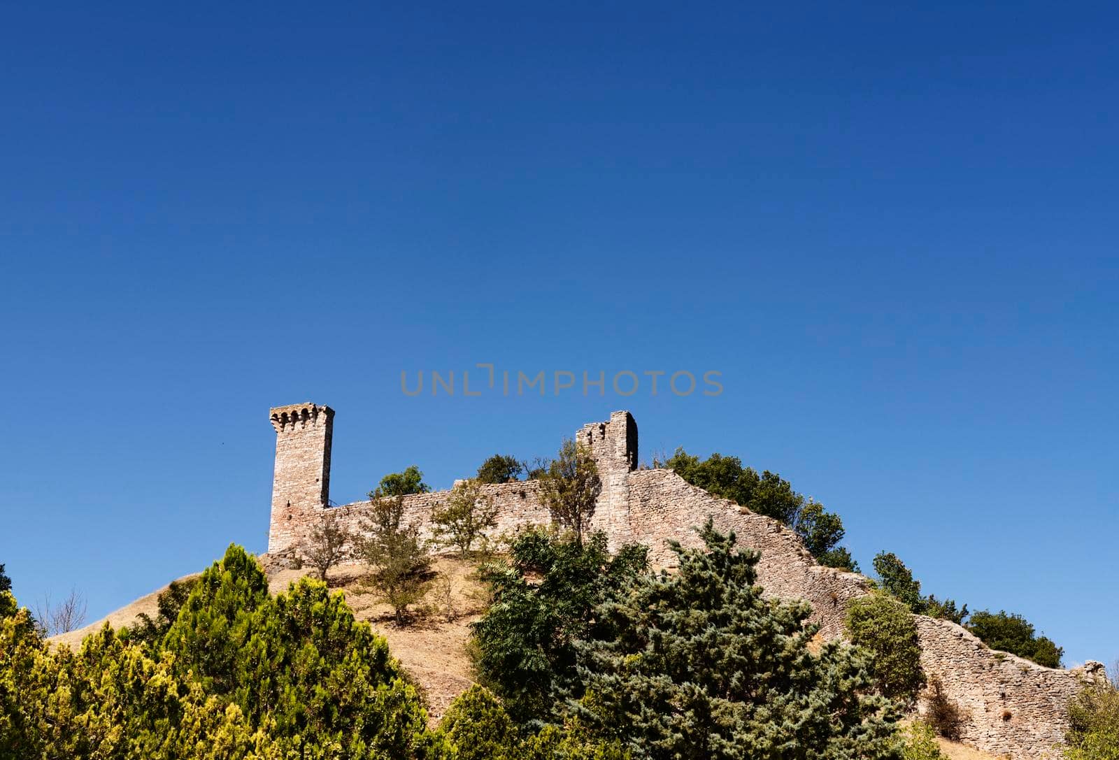 Assisi, Italy September , 5 , 2021, fortified walls of  Rocca Maggiore fortress reconstructed in 1356, medieval military architecture