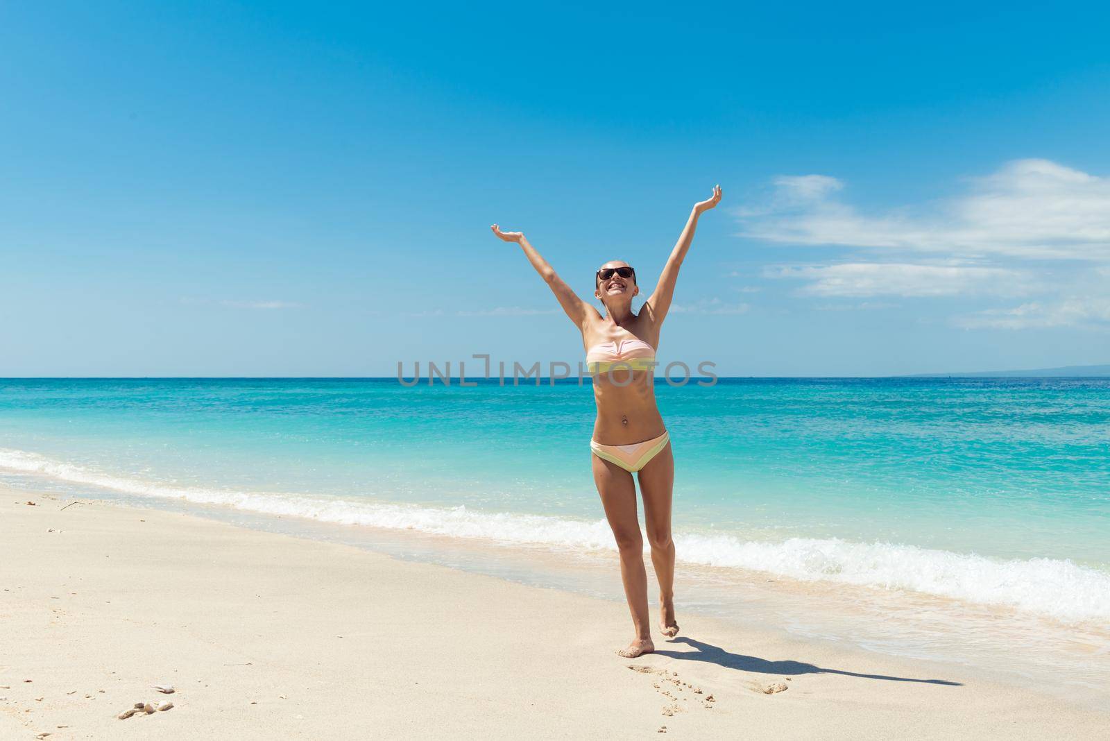 Young sexy woman wearing bikini at the beach