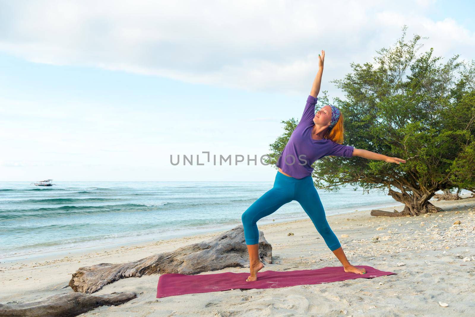 Young woman practicing yoga at exotic Bali location