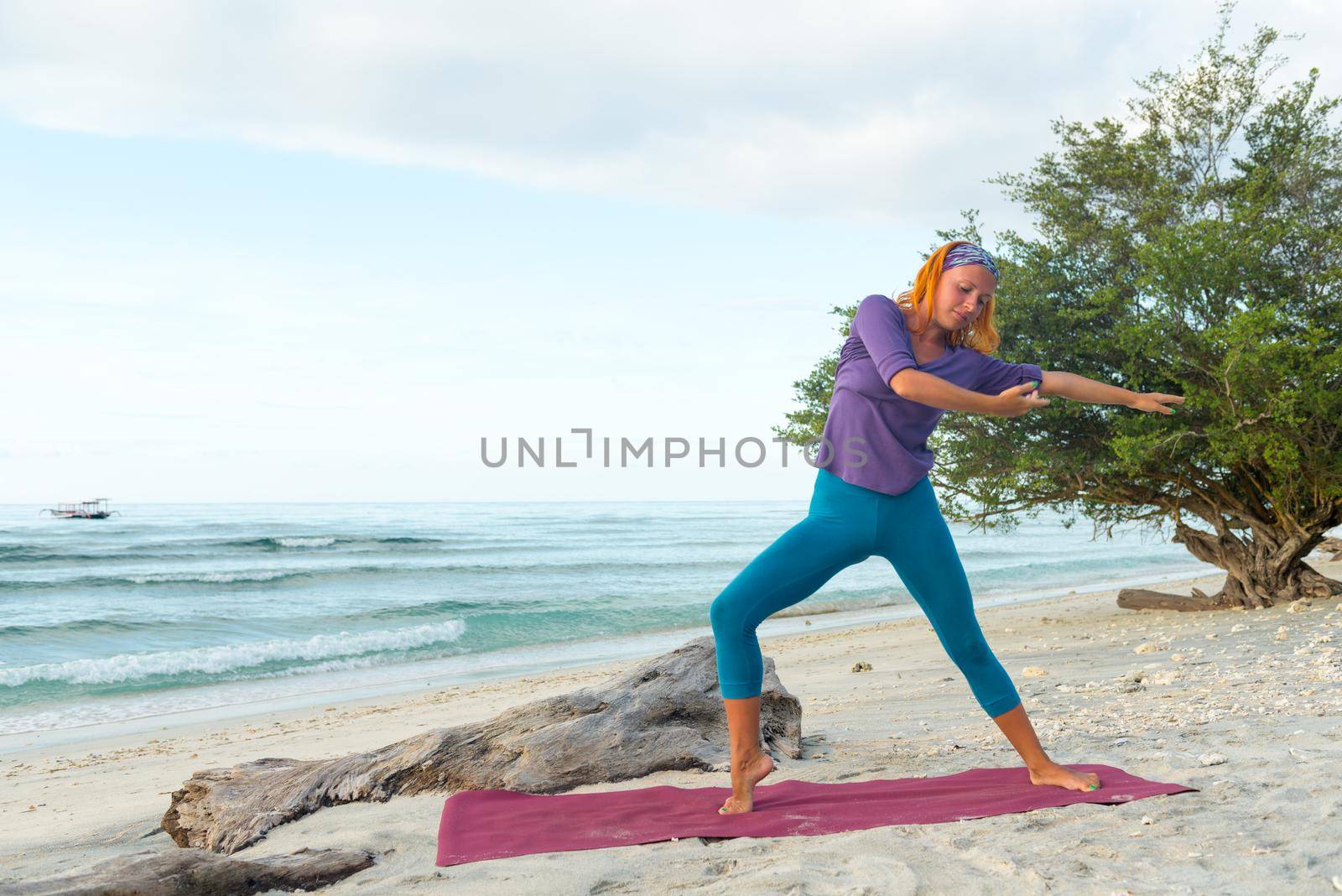 Young woman practicing yoga at exotic Bali location